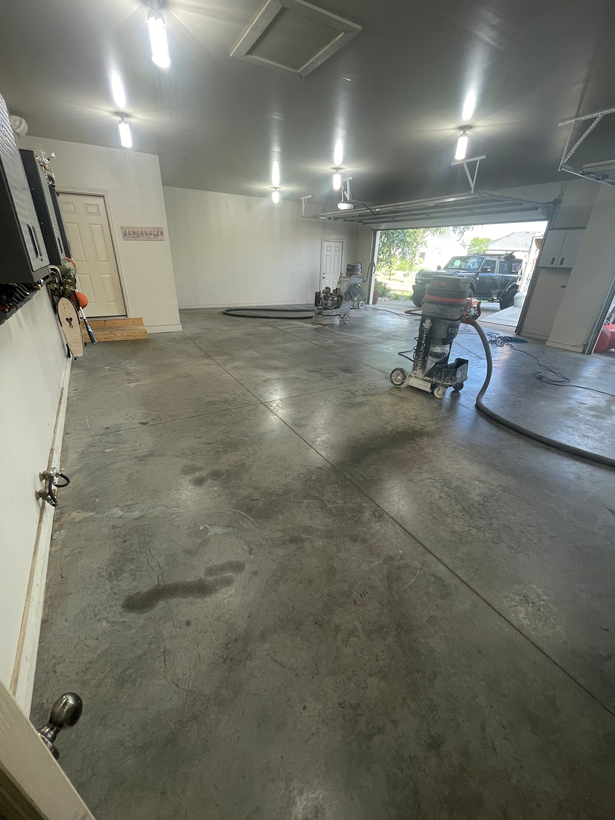 Coyote Flake Garage Floor Coating in Sioux Falls with Trench Drain by Select Painting, Coatings & Garage Cabinets