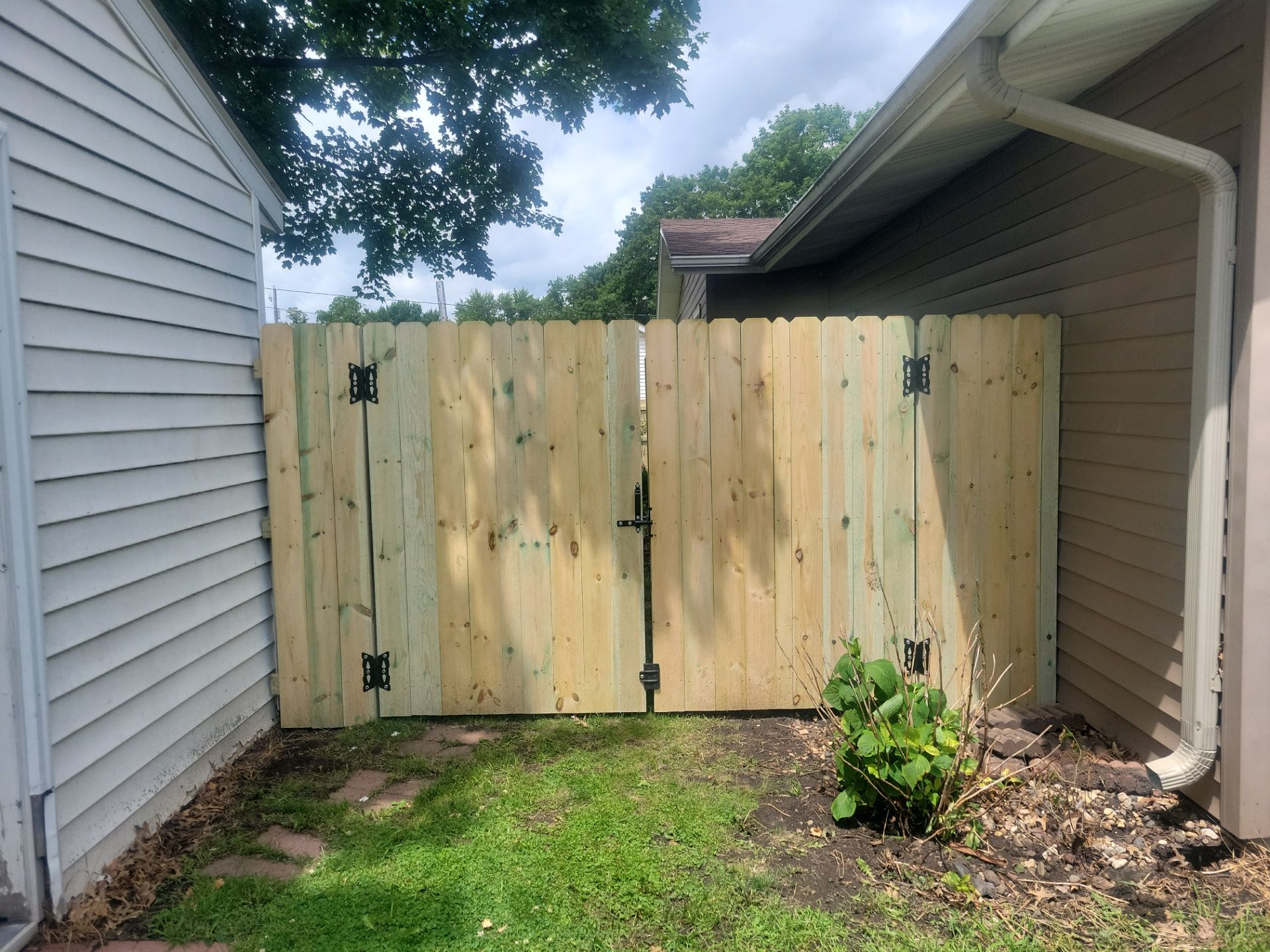 Pressure-Treated Wood Privacy Fence Installation in Charles City by Perfect Picket Fence and Stain