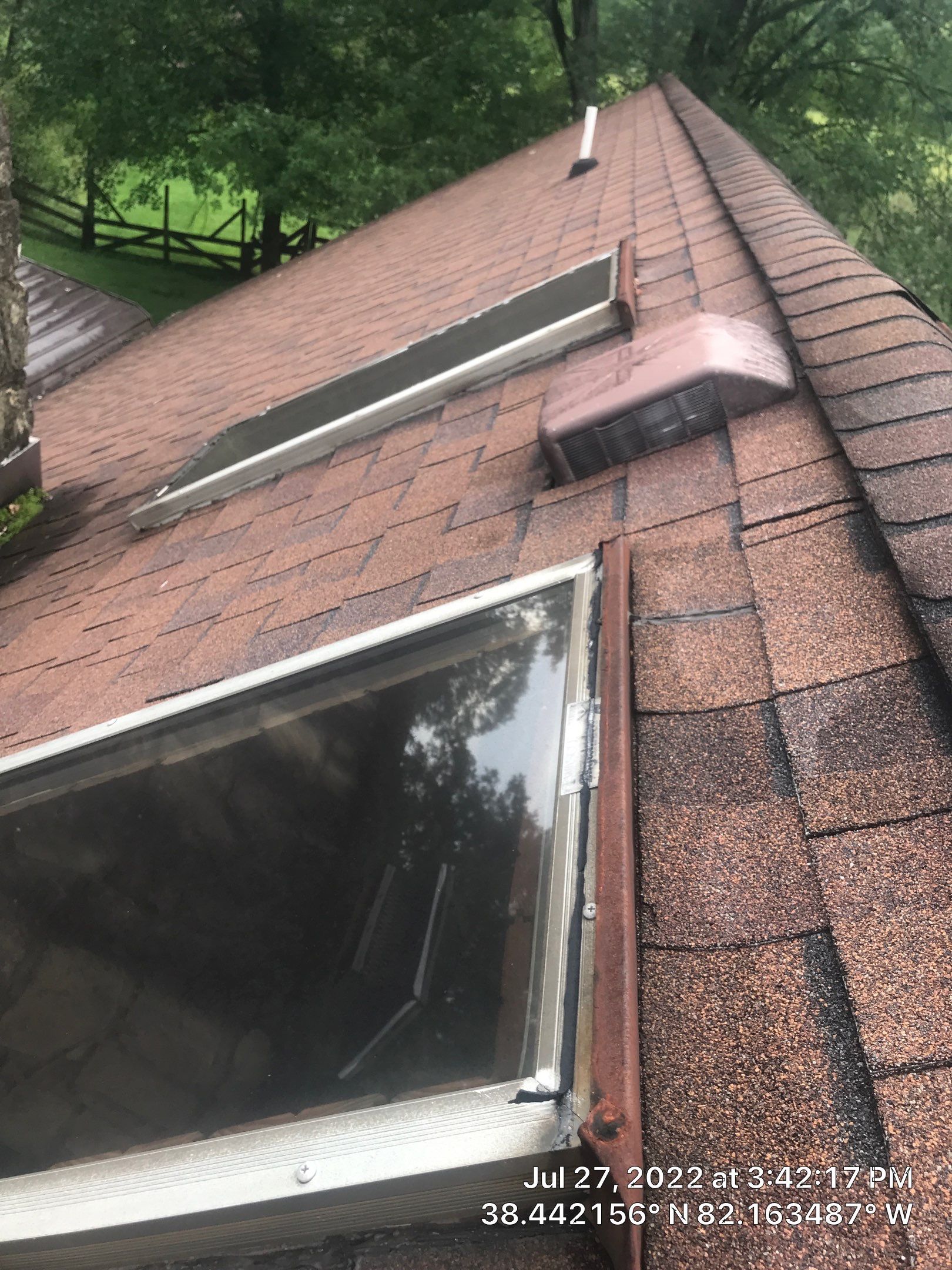 Shingle Roofing with Velux Skylight replacement and stone chimney flashing  by Secure Construction Company Inc