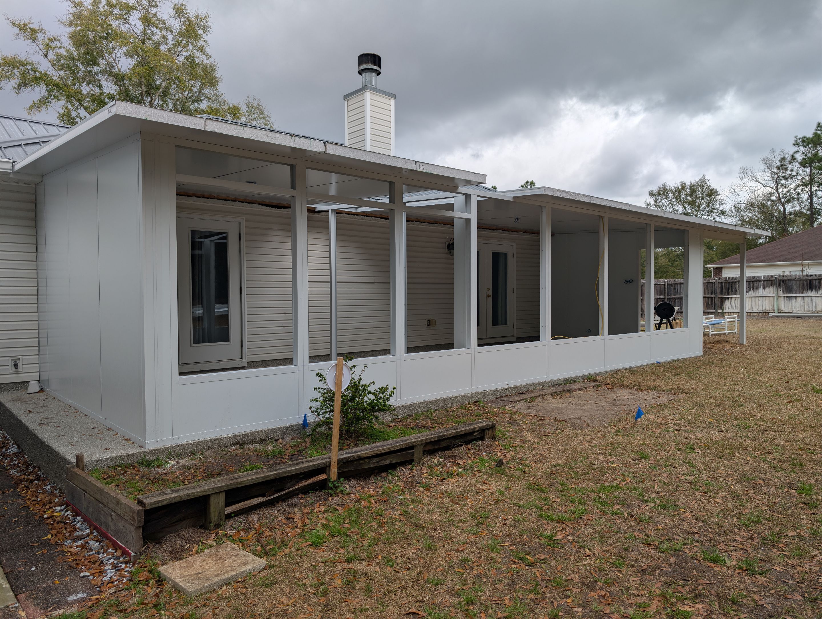 Large Divided Glass Room with Patio cover by Titan Sunrooms