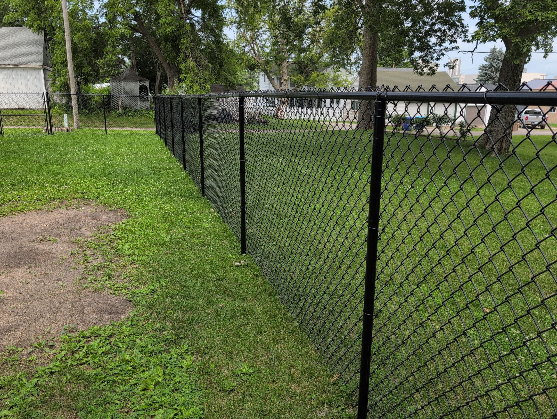 Black Vinyl Coated Chain Link Fence Installation in Independence by Perfect Picket Fence and Stain