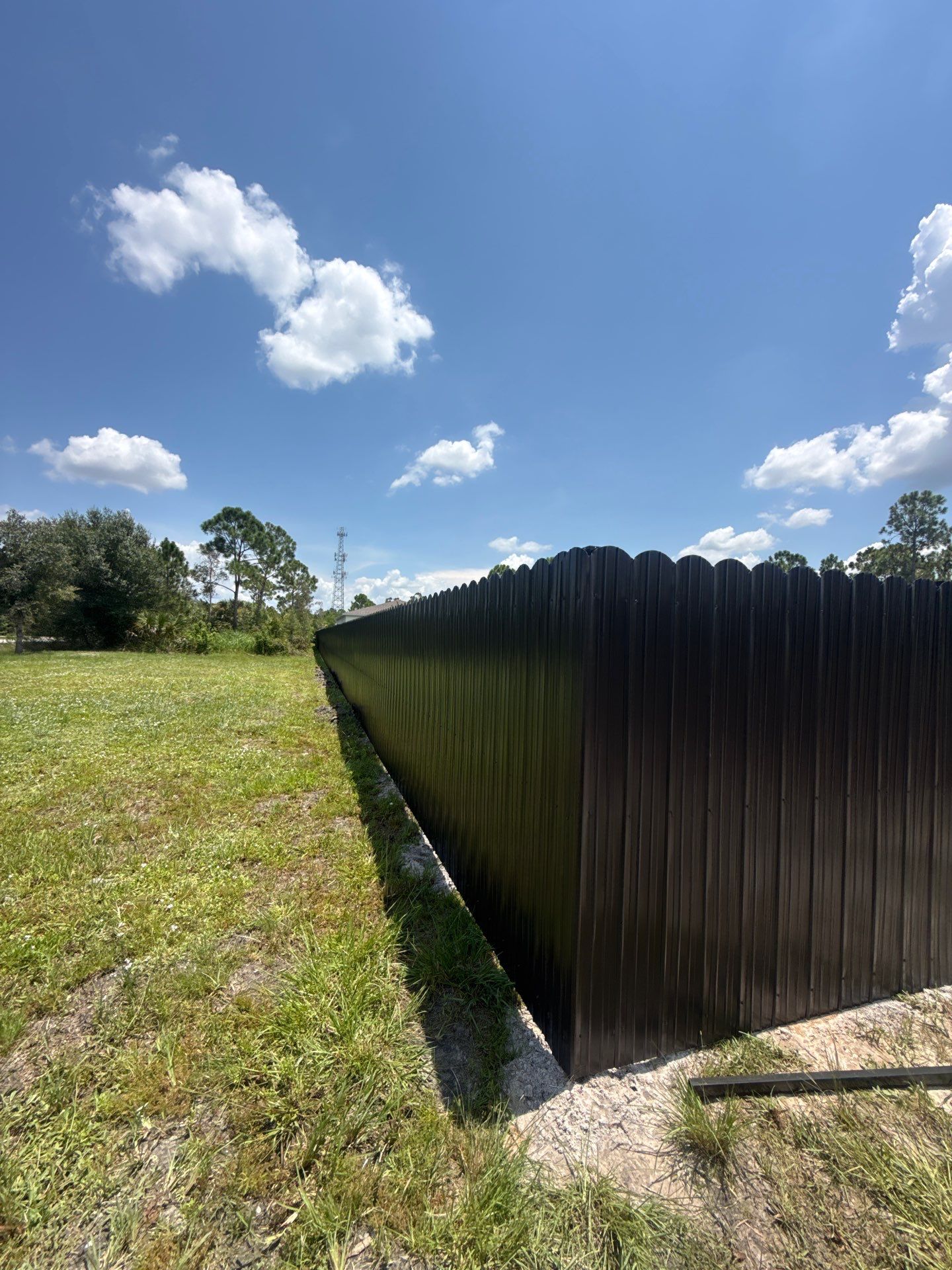 Black Scalloped Metal Privacy Fence Installation in Punta Gorda by True Fence LLC