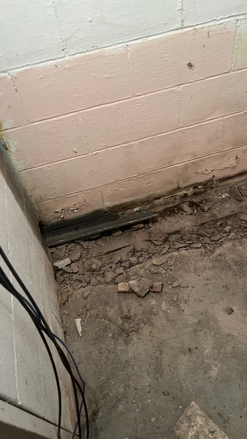 Interior drain tile system installation by ACE Waterproofing & Basement Solutions