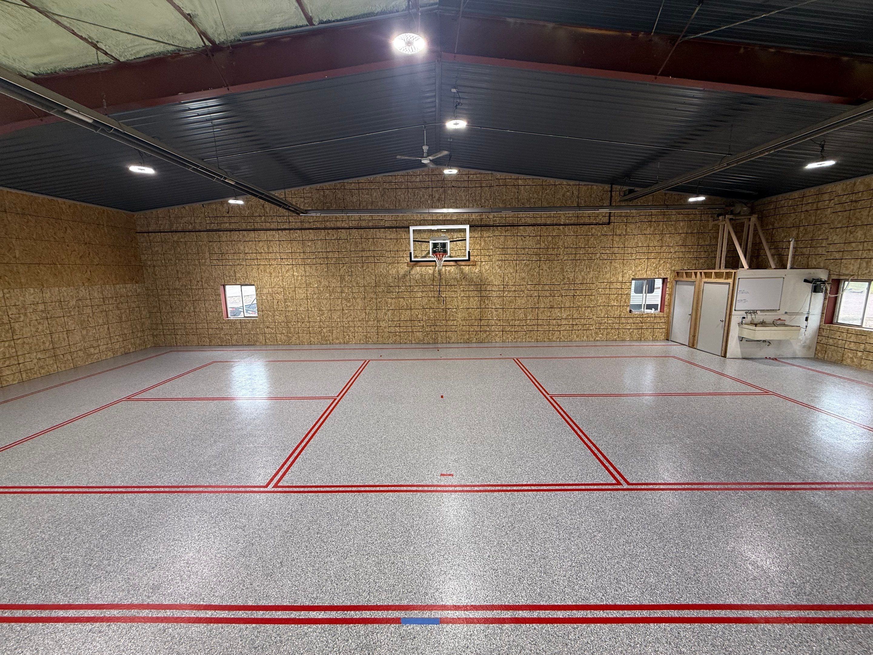 Custom Polyurea Shop Floor with Basketball Court Lines in Rock Valley by Select Painting, Coatings & Garage Cabinets
