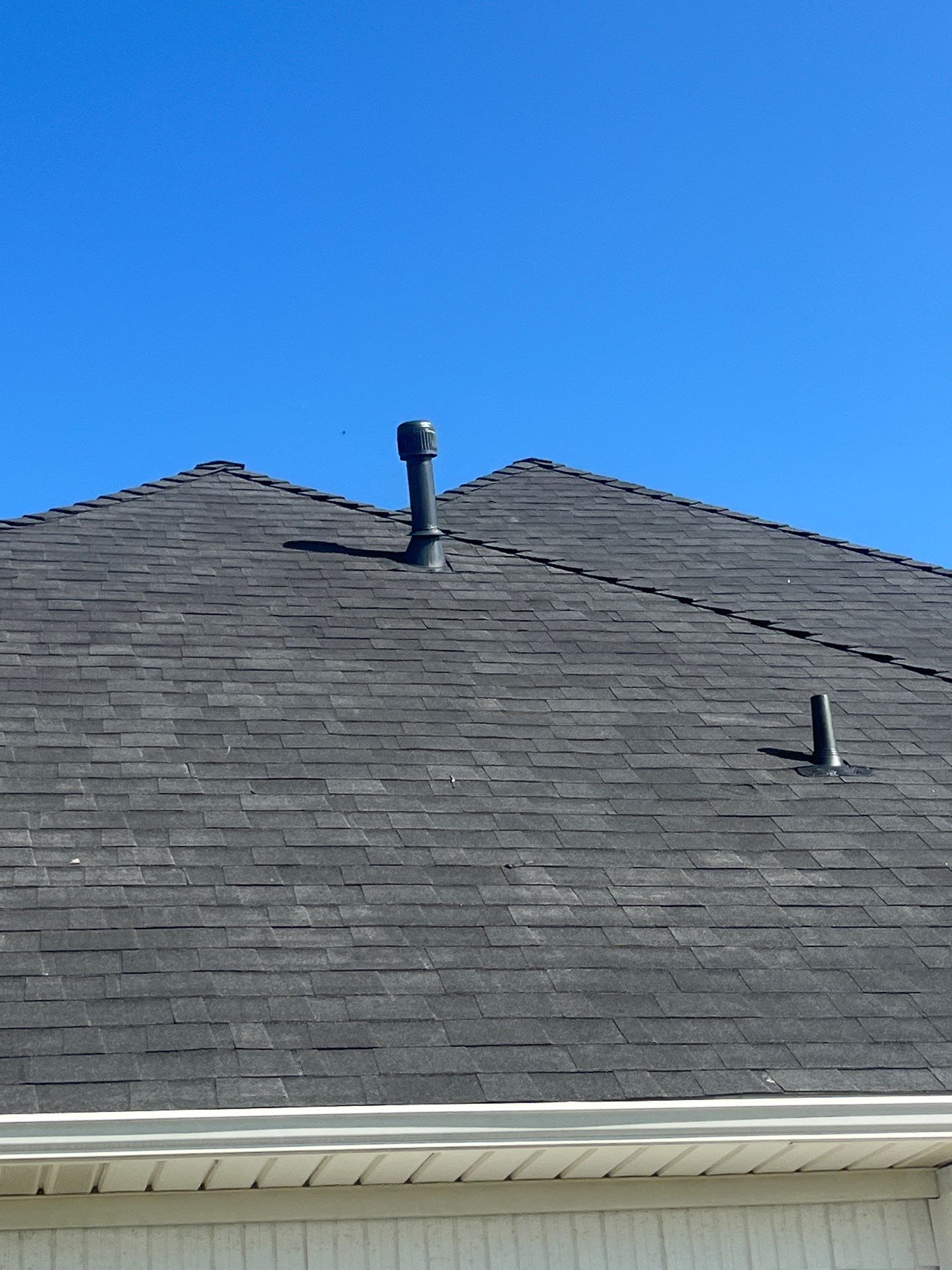 White brick with Malarkey Brilliant Black by Tejas Roofworks + Restoration