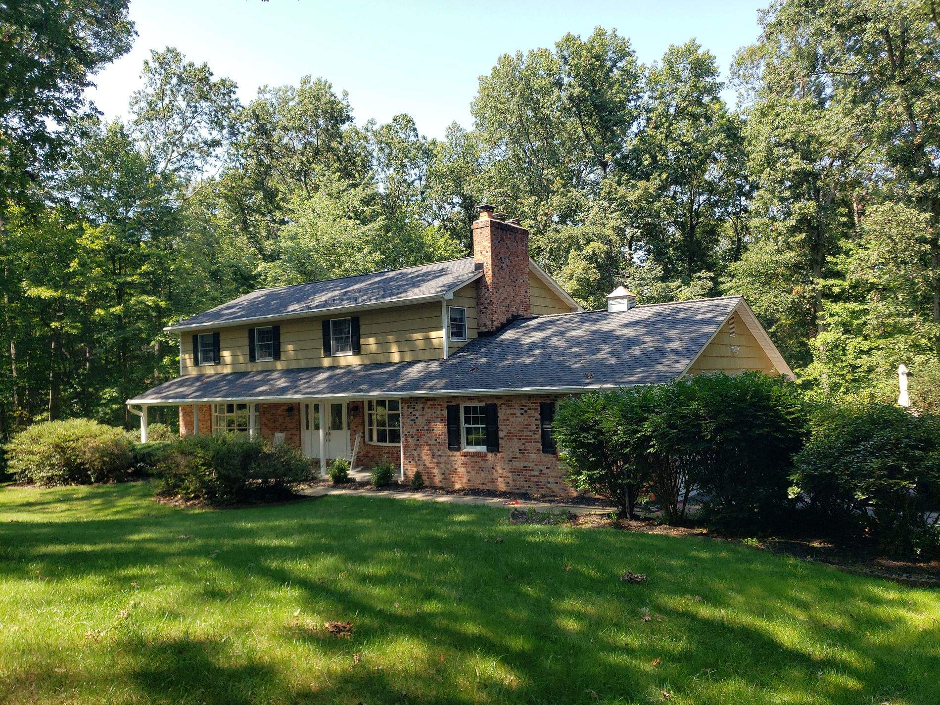 White Board & Batten Siding with Black Trim by Roof Right Inc