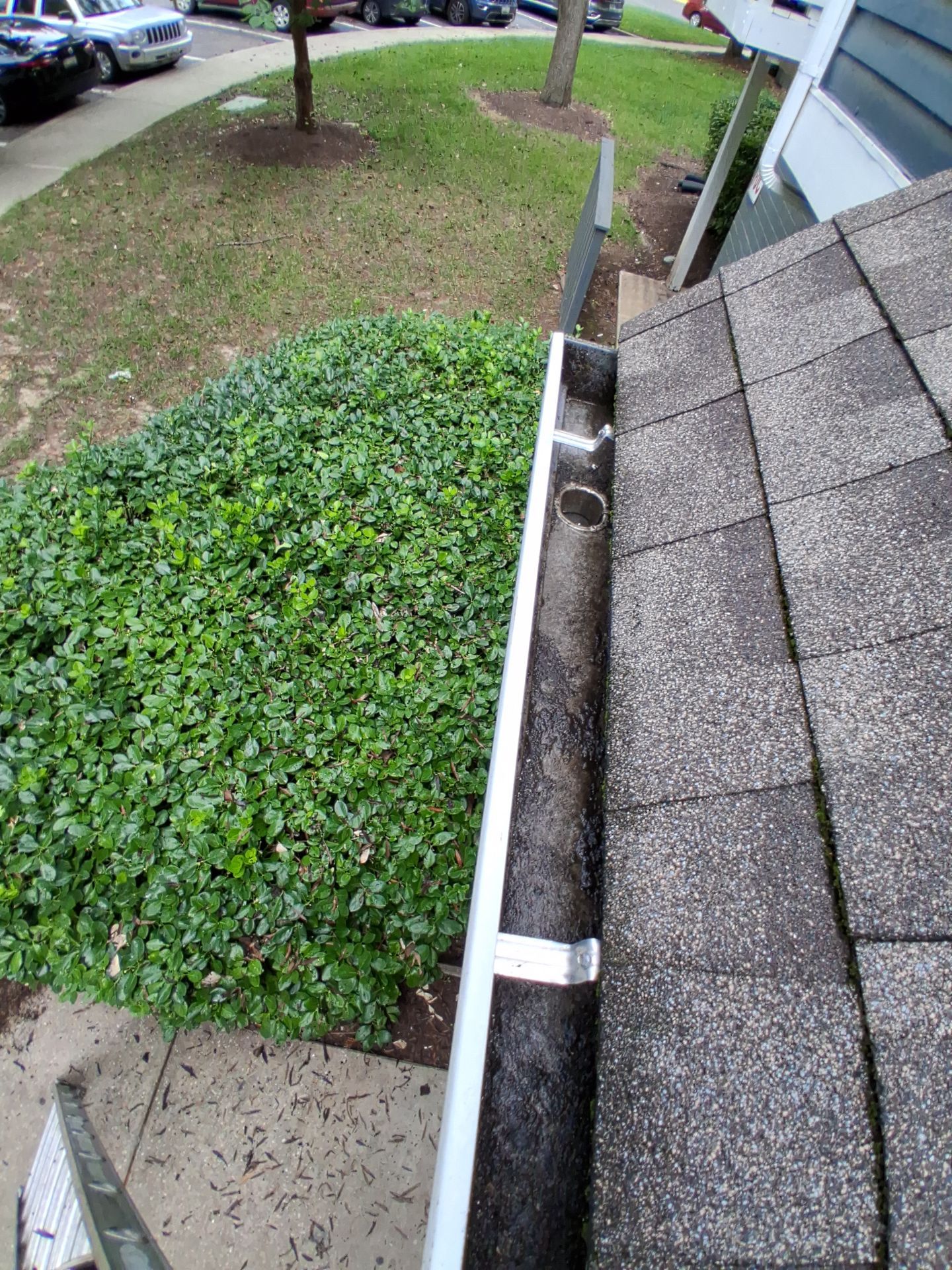 HOA gutter cleaning in Bowie & Largo, MD, after  photo showing full gutters.