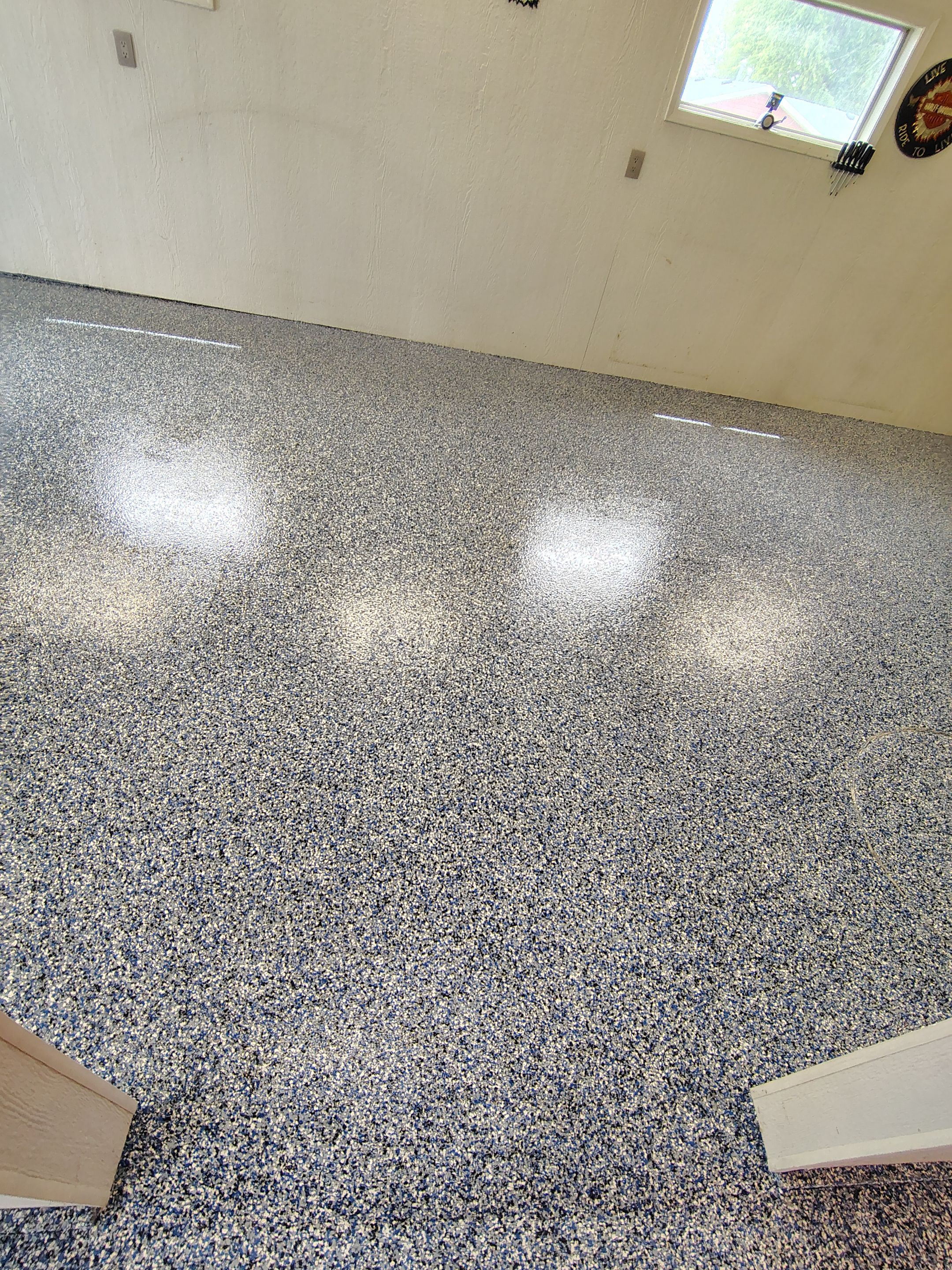Custom Grey Flake Epoxy Garage Floor Installation in Remsen by Select Painting, Coatings & Garage Cabinets