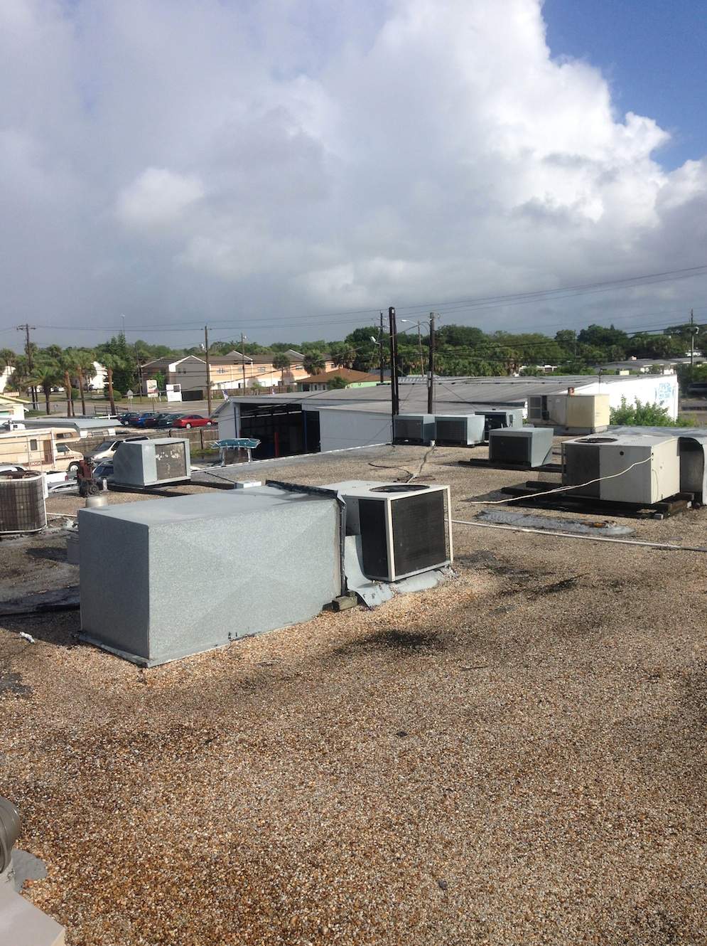 White Reflective Commercial Roof Coating Installation in Melbourne FL by Florida Roofing and Renovations Inc.