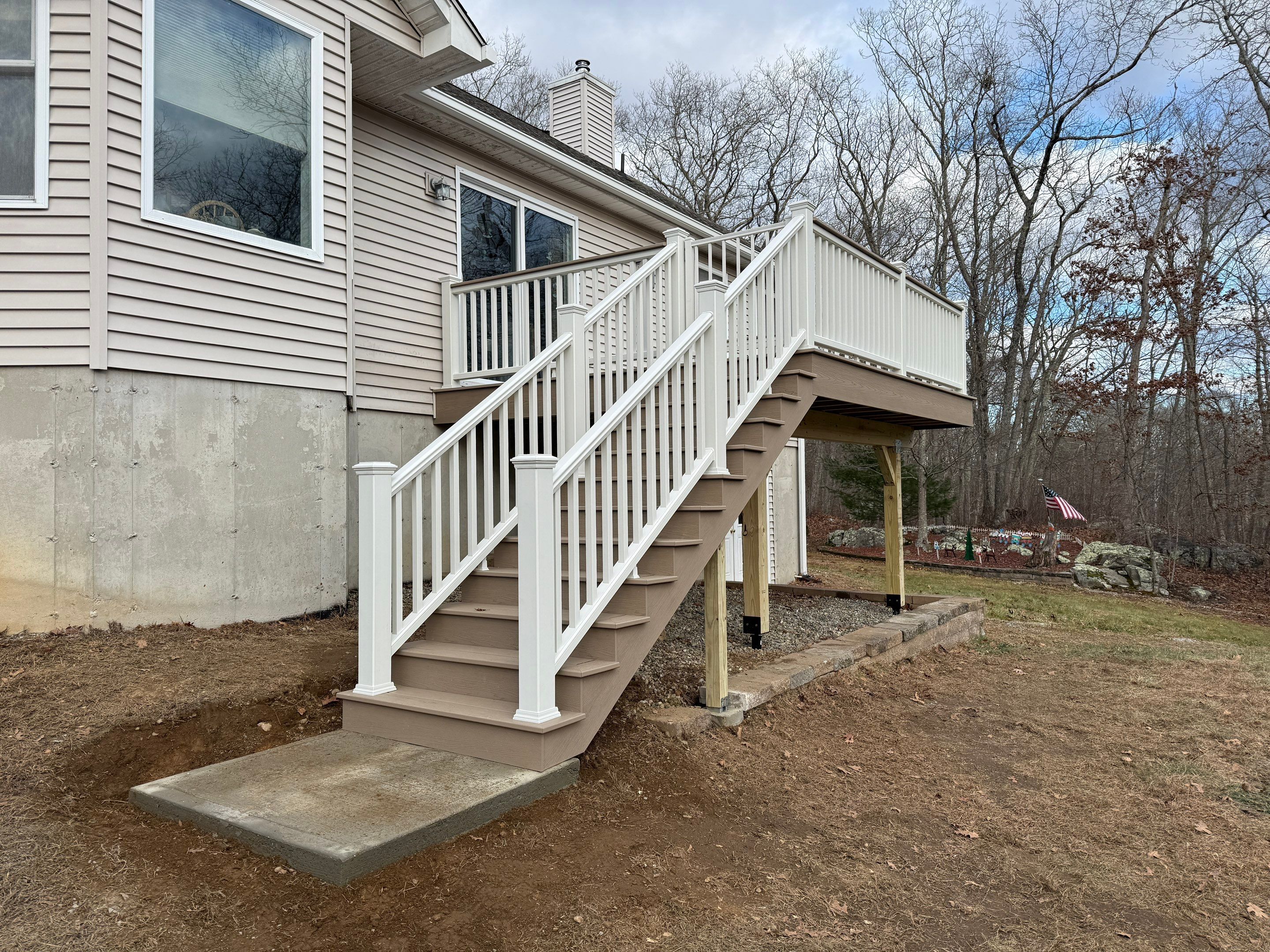 Replacement deck using Trex Transcend Ropeswing and White Transcend railings, with gate by DiGiorgi Roofing and Siding Inc