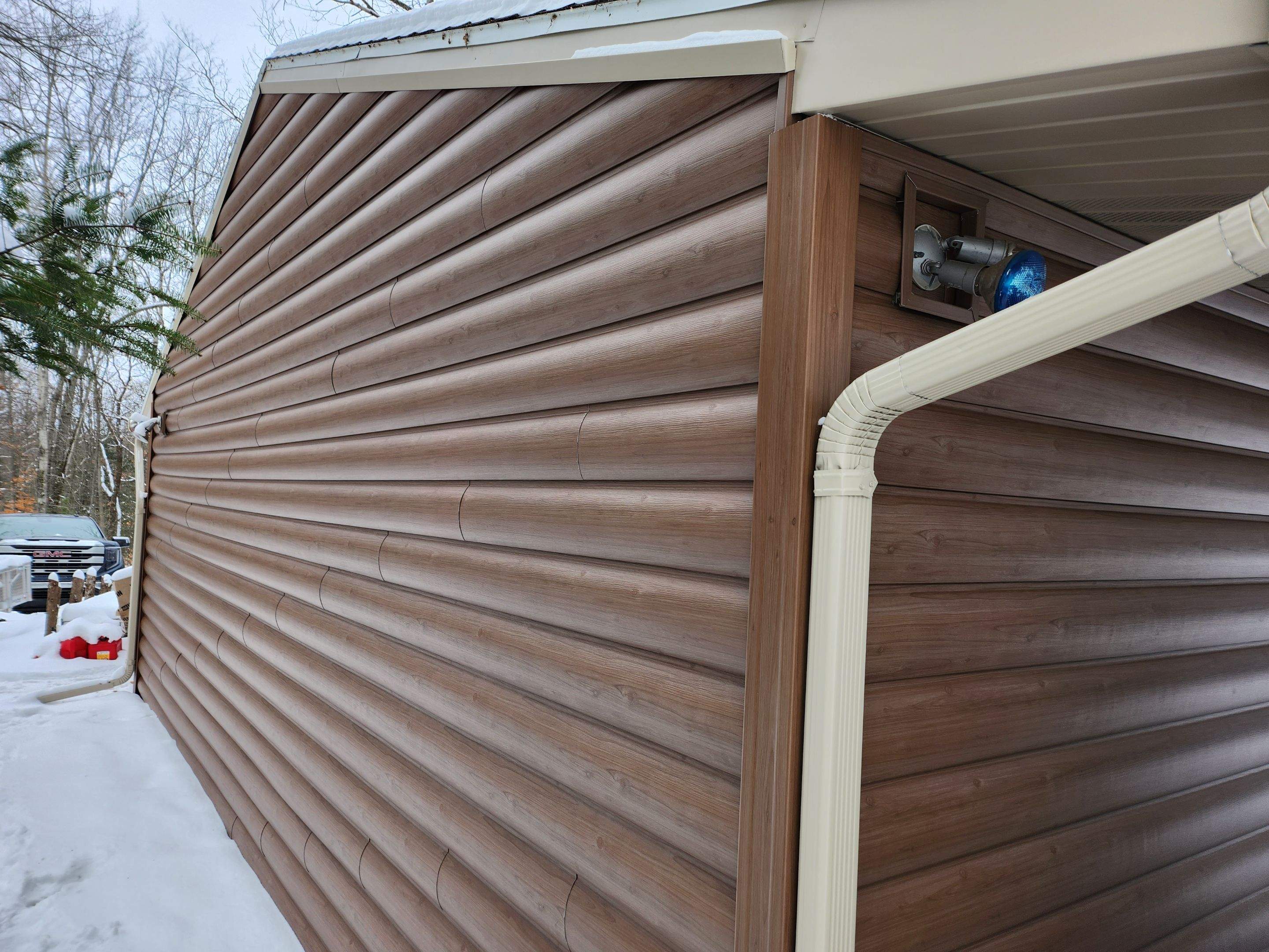 New addition and log siding by Energy Plus Home Improvements