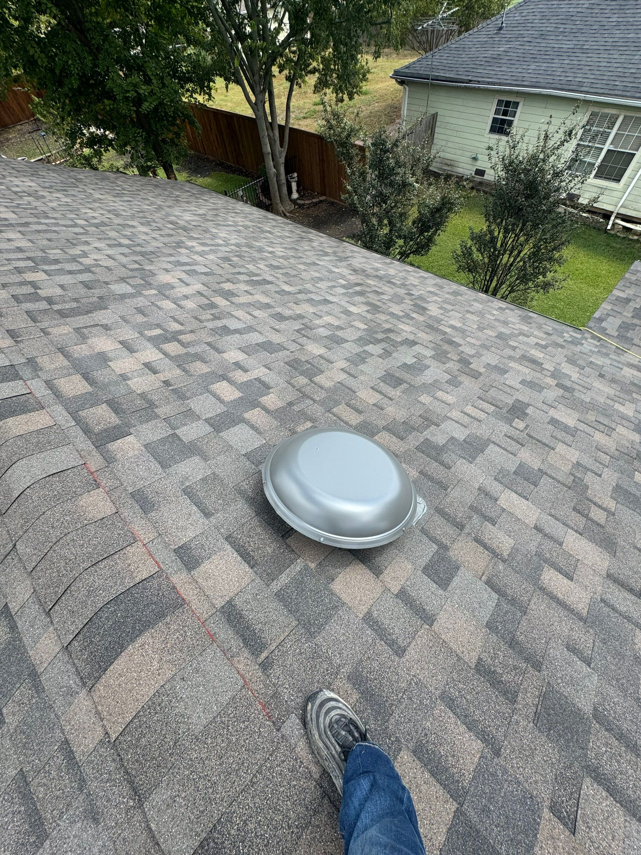 IKO Driftshake-Dark green siding house by Tejas Roofworks + Restoration