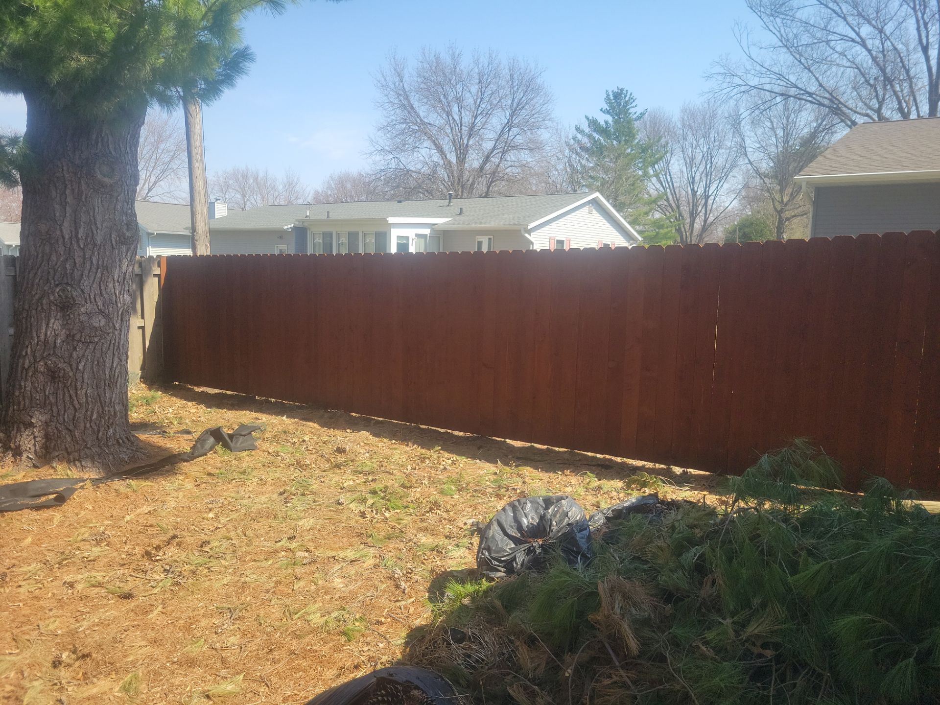 Stained Cedar Wood Privacy Fence Installation in Cedar Falls by Perfect Picket Fence and Stain