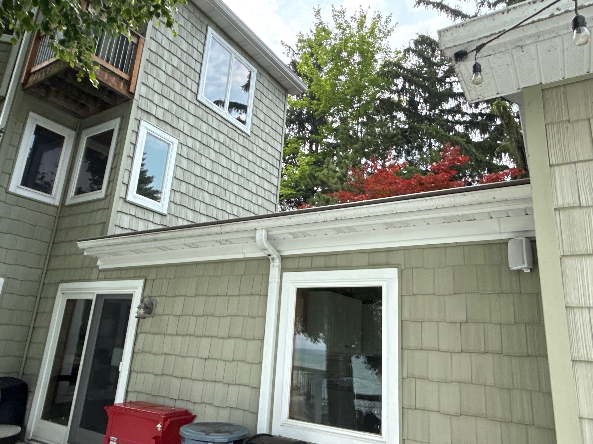 Gutter Helmet Protection System for Suttons Bay Home with Cedar Siding by Rainbow Seamless Systems