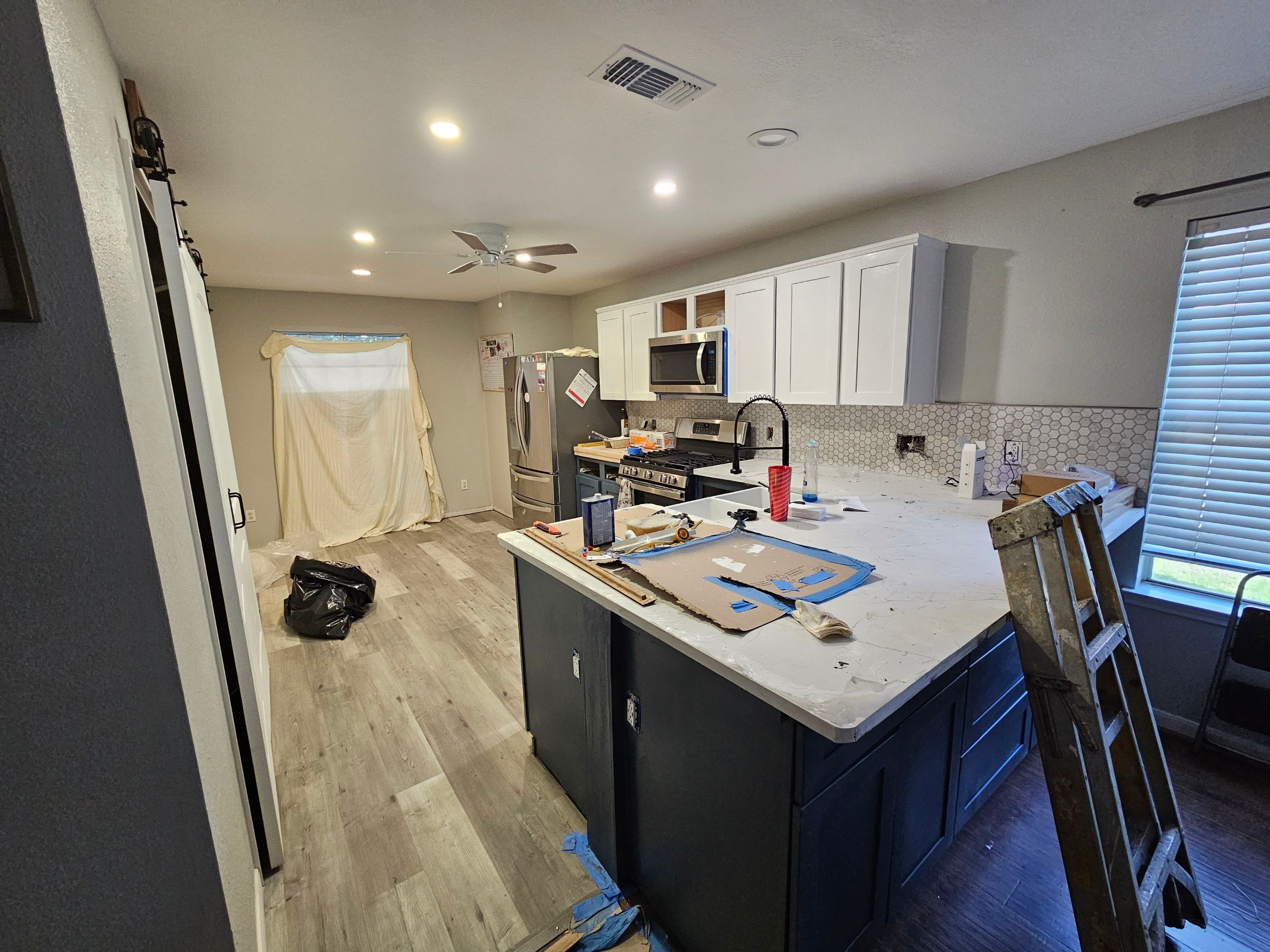 Modern Kitchen Remodel with Blue Cabinetry by Majesty Construction