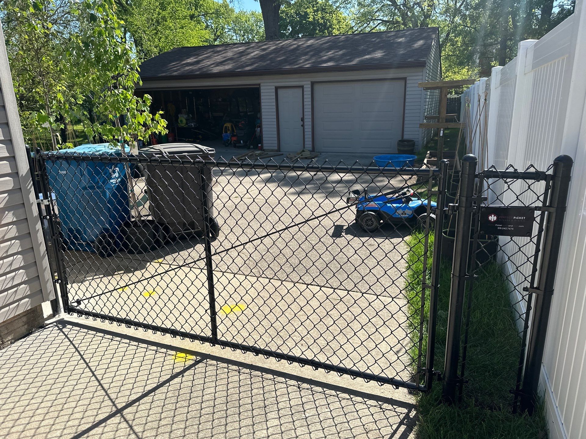 Black Chain Link Fence and Driveway Gate Installation in Waterloo by Perfect Picket Fence and Stain