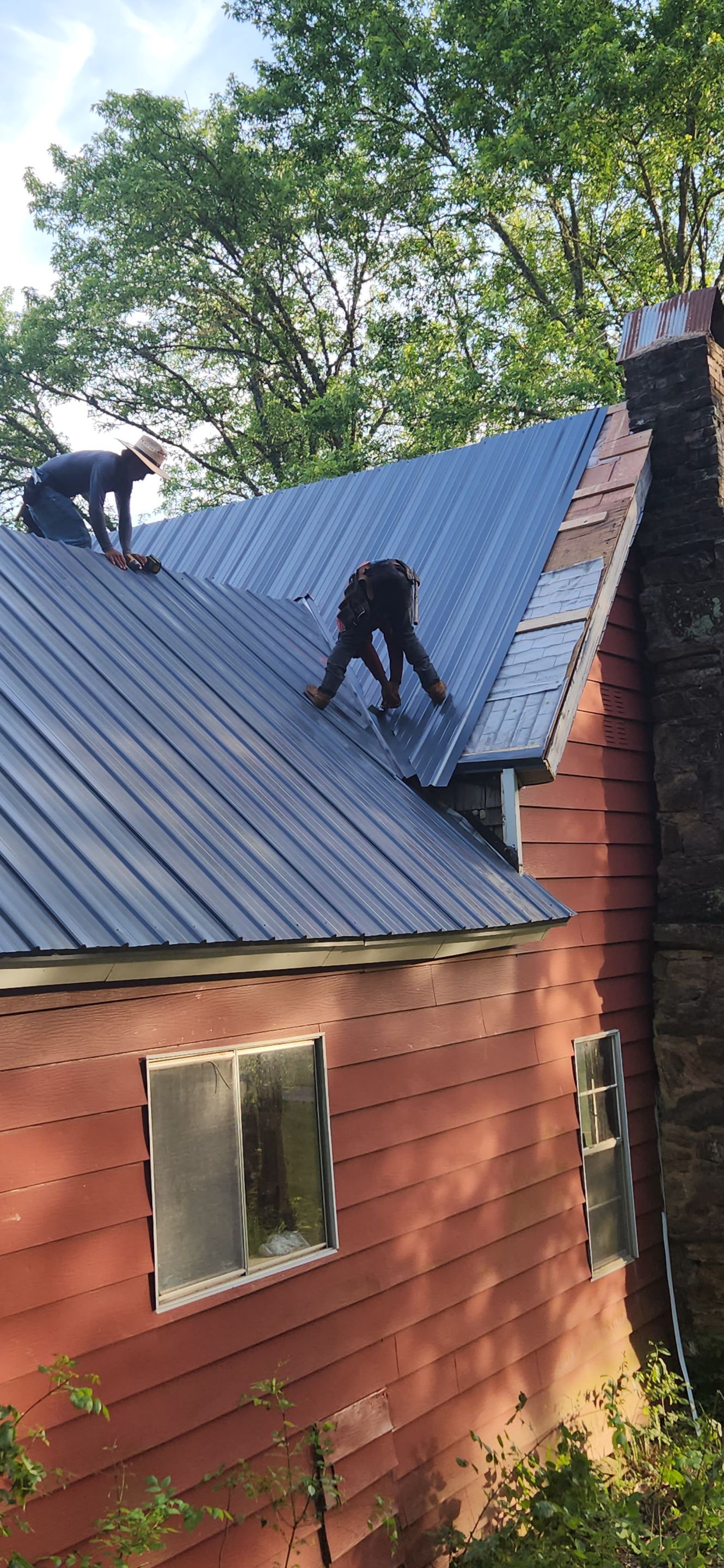 Residential Roofing Installation using 26 Gauge Colored Panels by Hostetler Roofing