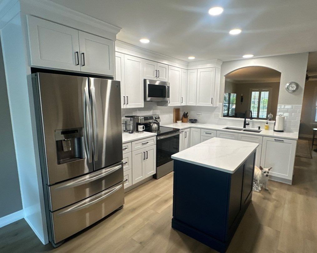 Live Oak Kitchen Refresh Featuring White Shaker Cabinets and Navy Island by Legacy Bath and Kitchen 