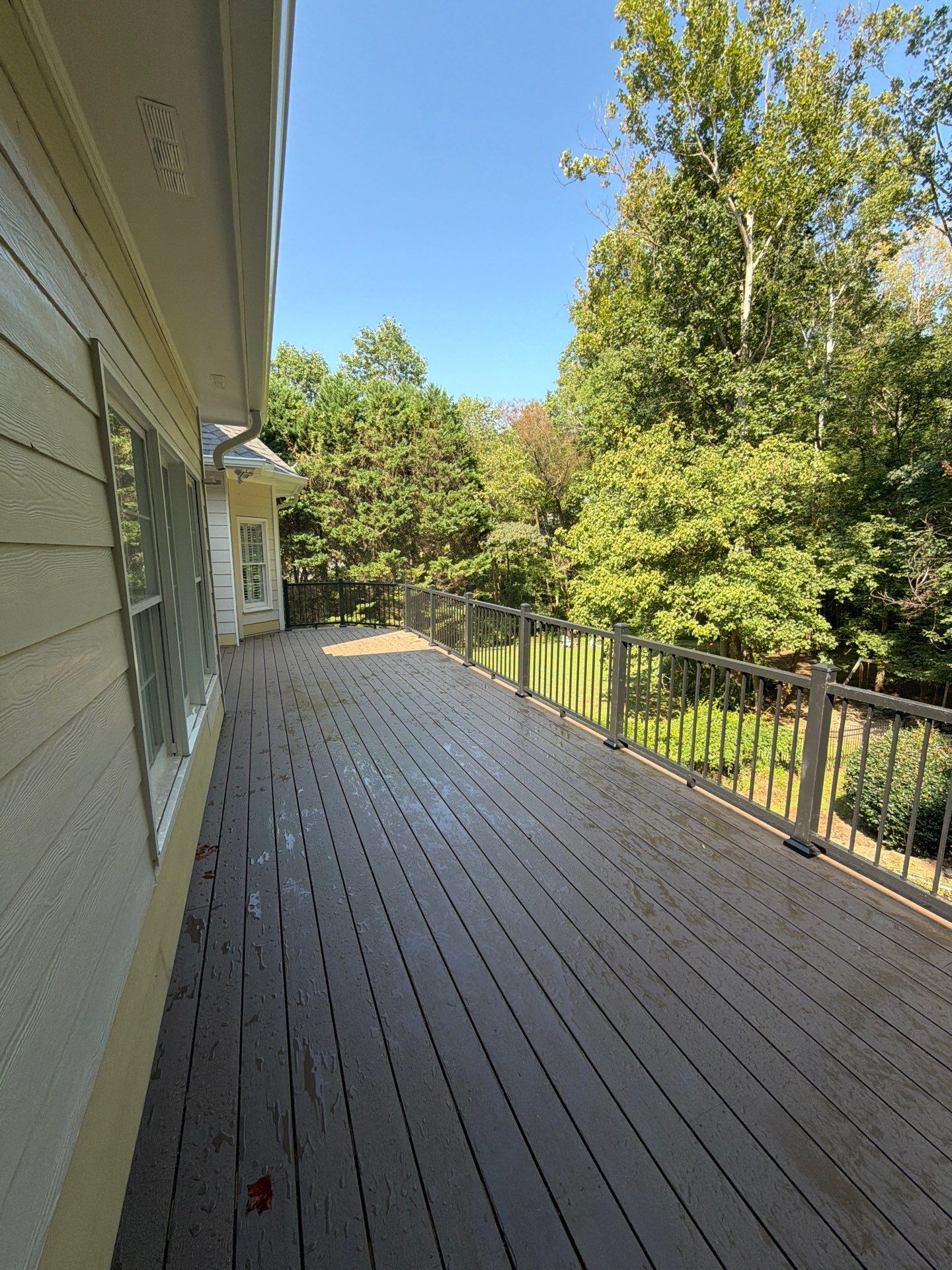 Elevated Composite Deck Replacement with Metal Railings in Smyrna by Swift Home Renovations 