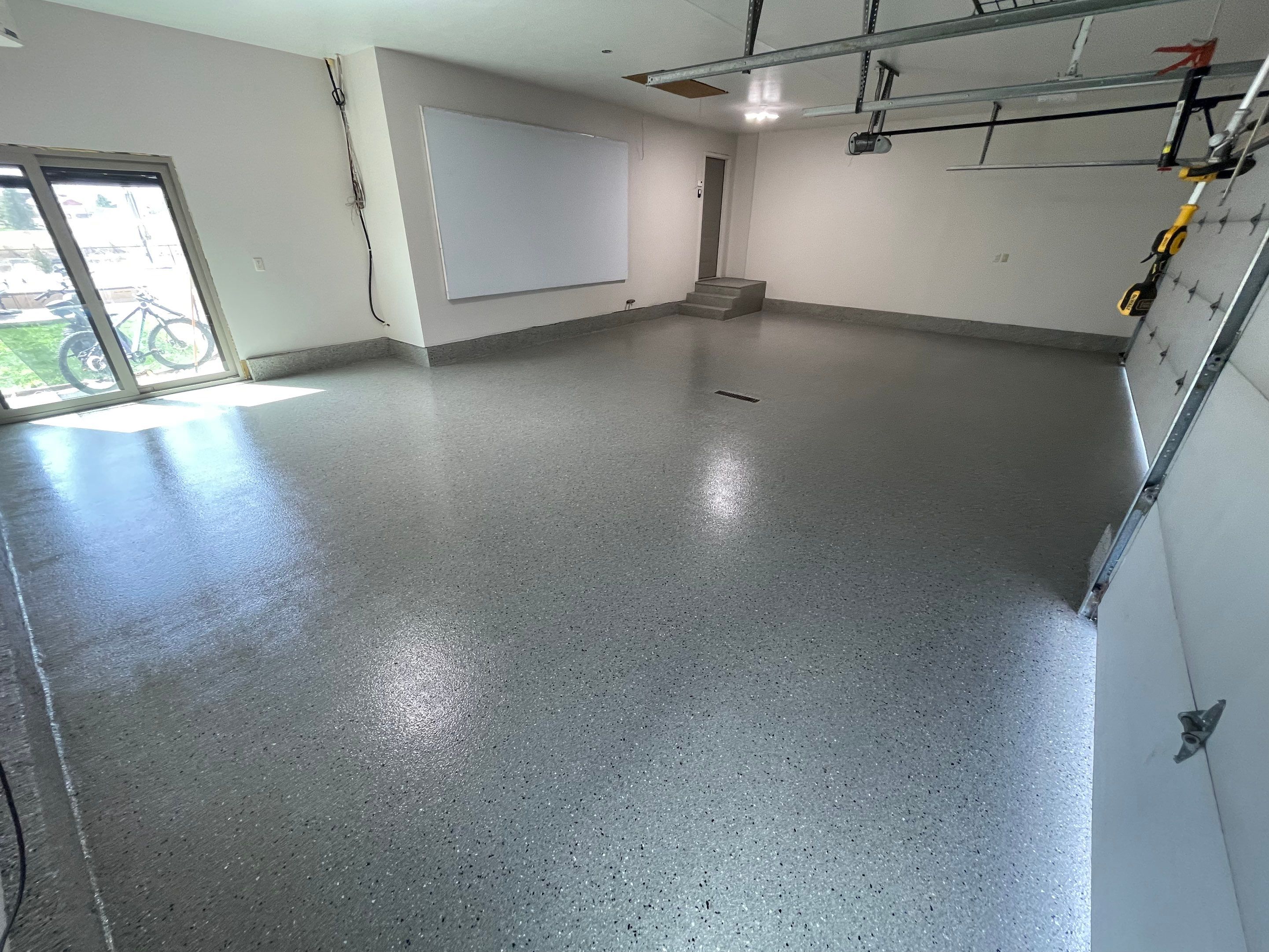 Residential Garage Floor Coating with Grey Speckled Epoxy Finish by Select Painting, Coatings & Garage Cabinets