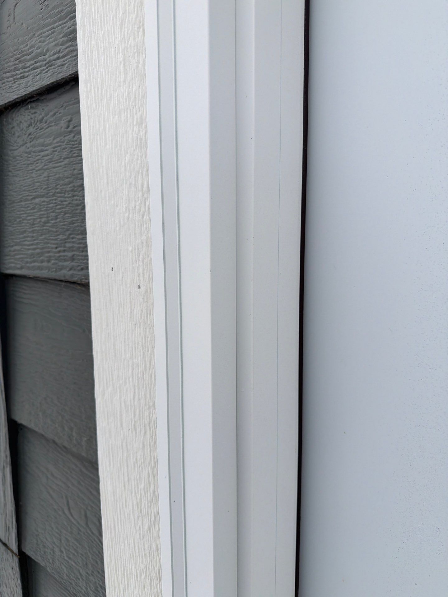 Madison Exterior Remodel with Dark Gray Siding and Stone Accents by Select Painting, Coatings & Garage Cabinets
