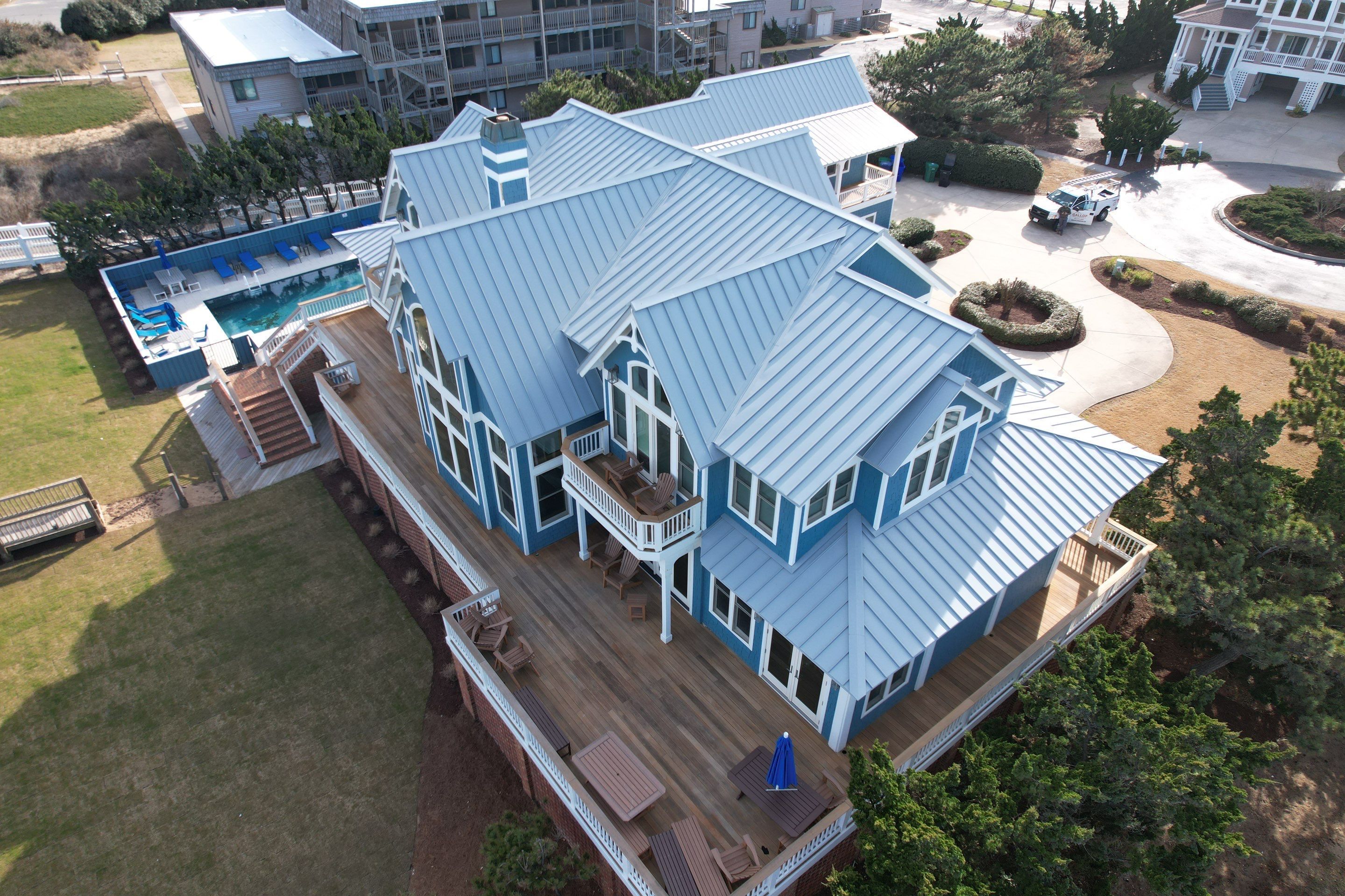 Large Metal Roof Transformation by Gallop Roofing & Remodeling, Inc.