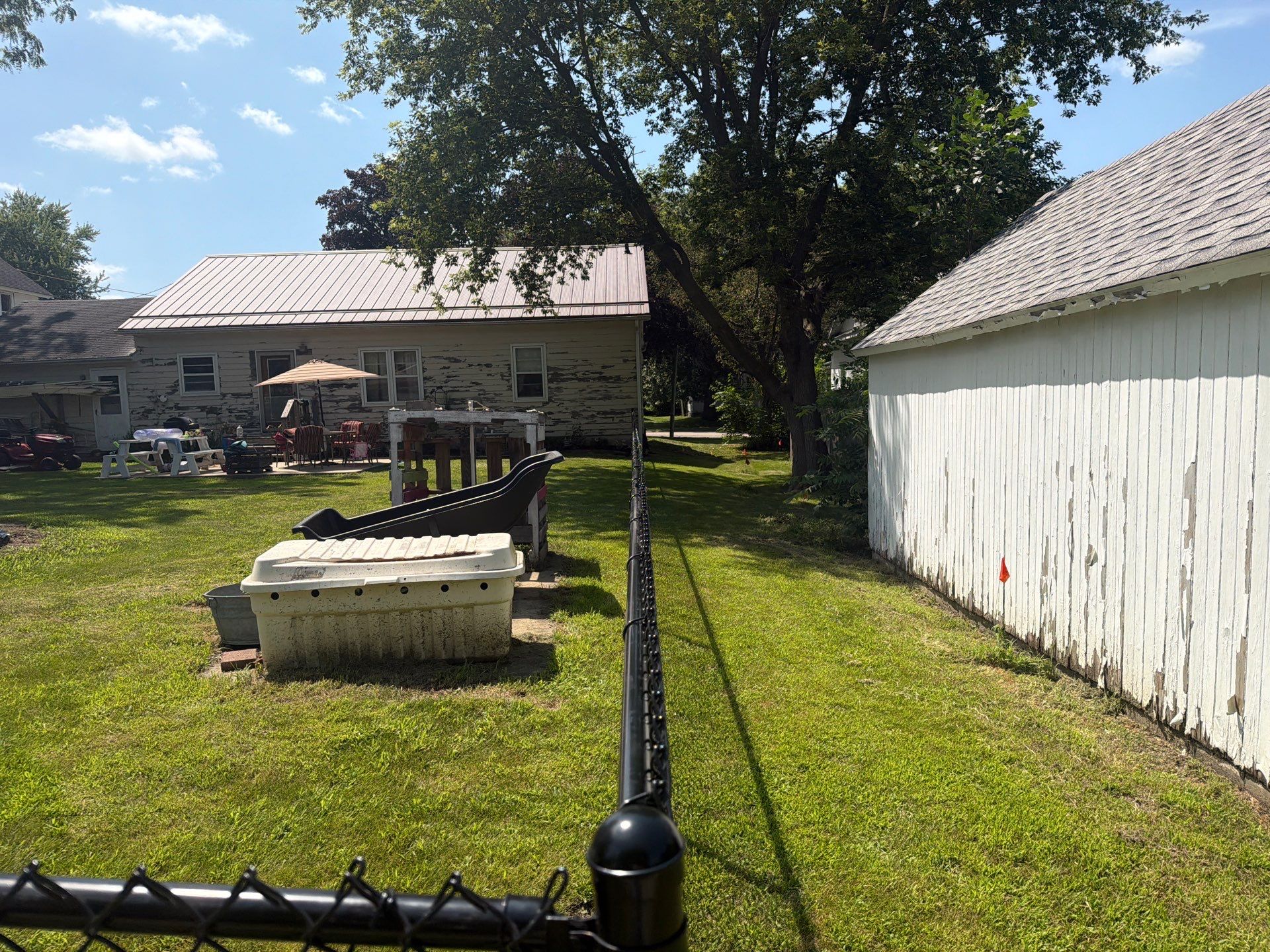 Black Chain Link Backyard Fence Installation in Tripoli, IA by Perfect Picket Fence and Stain