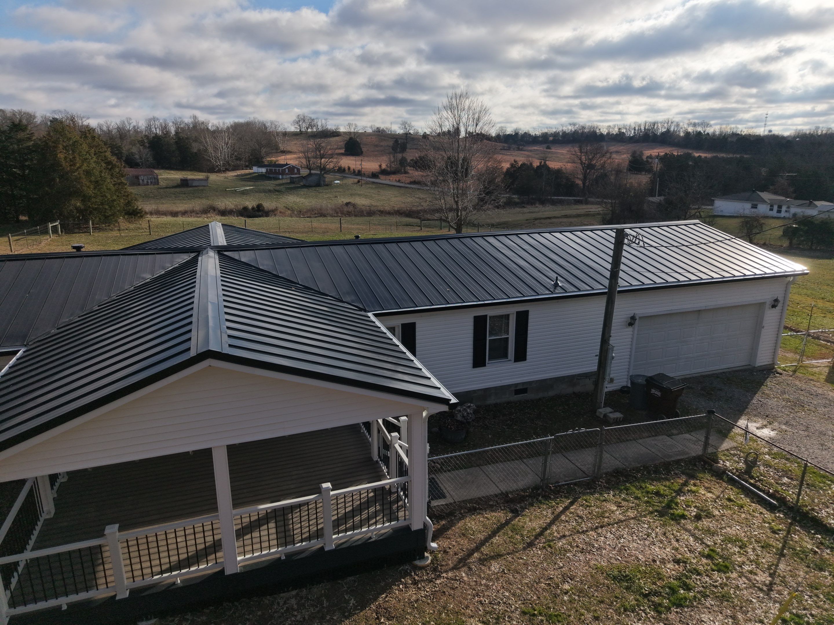 Standing Seam Roof & Black Gutters by Stout Exteriors