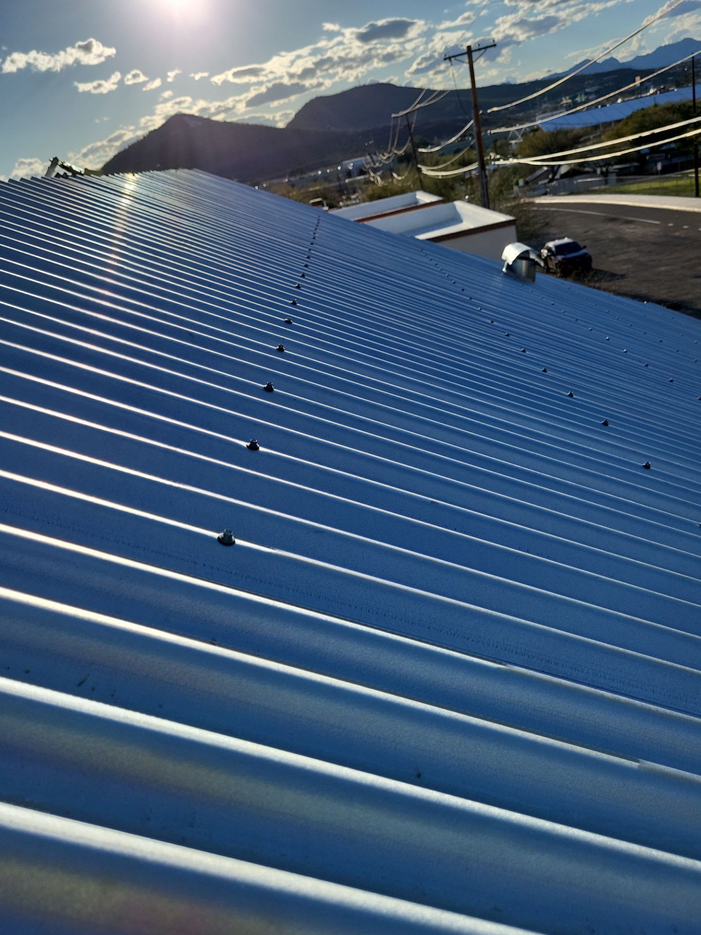 Metallic Silver Exposed Fastener by Reimagine Roofing