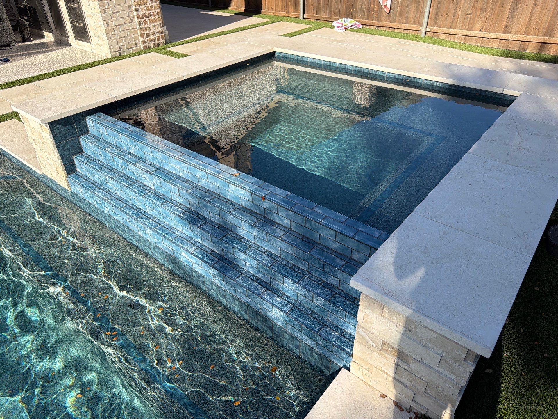 Modern Geometric Pool with Tile Waterfall Wall and Fire Bowls by Pinnacle Pools and Spas - DFW