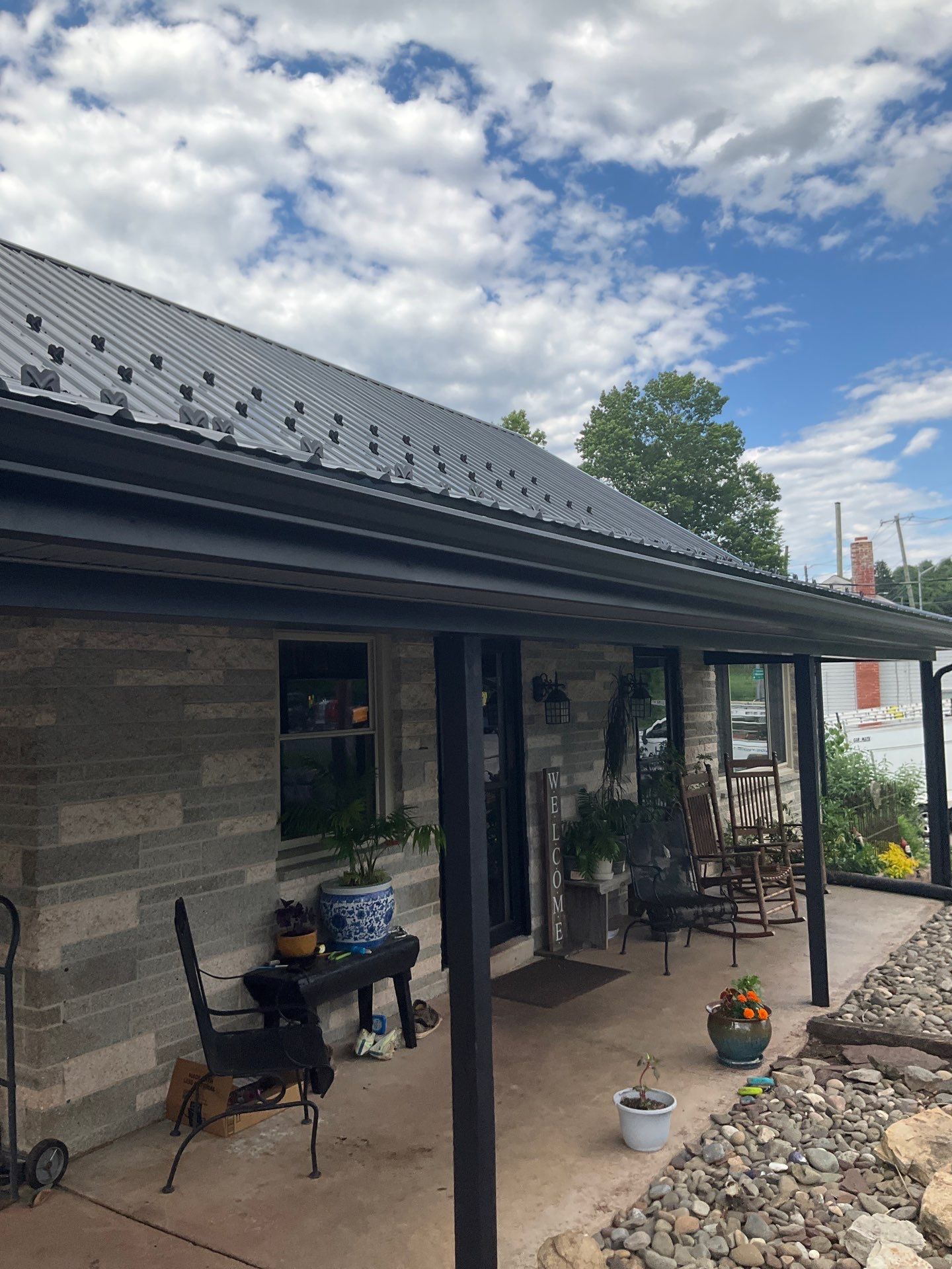 Metal Roofing, Board & Batten Siding, and Entry Door Transformation by Esh Builders