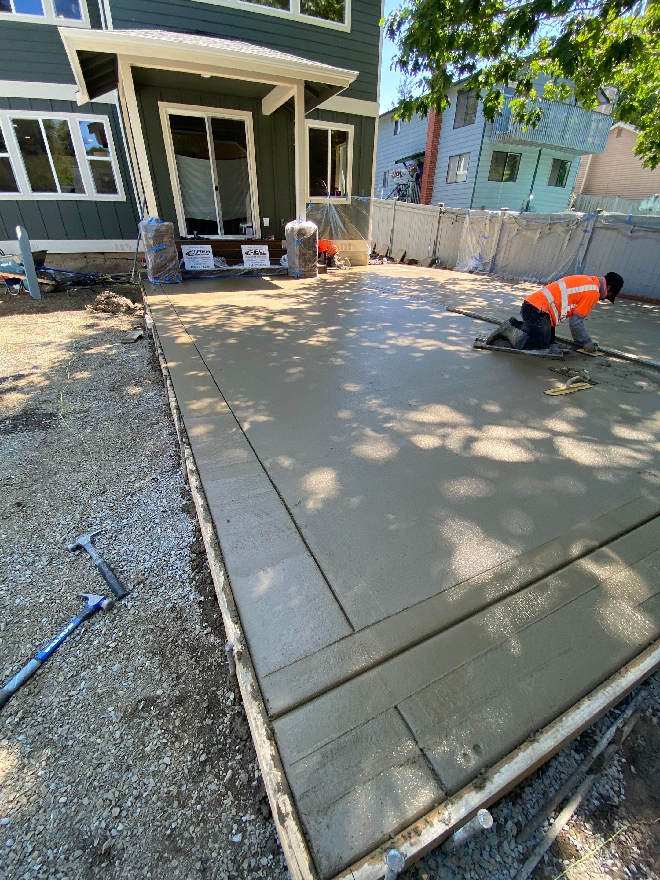 Patio Installation using Concrete, Retaining walls, and Turf install by Jireh Asphalt & Concrete Inc 