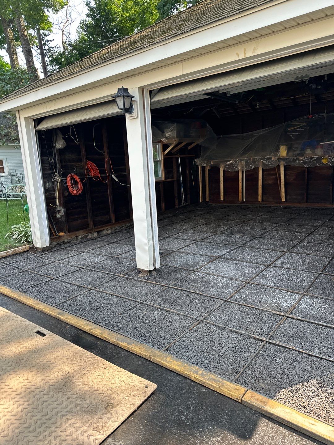 Concrete garage floor replacement with a broom finished apron by NG Masonry & Construction LLC