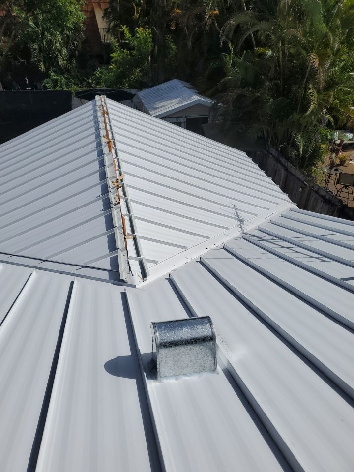 Residential Roofing Installation using 1.5" Nail Strip 24ga Solar White Kynar Coated Standing Seam Metal Panels by Morton Roofing, Inc.