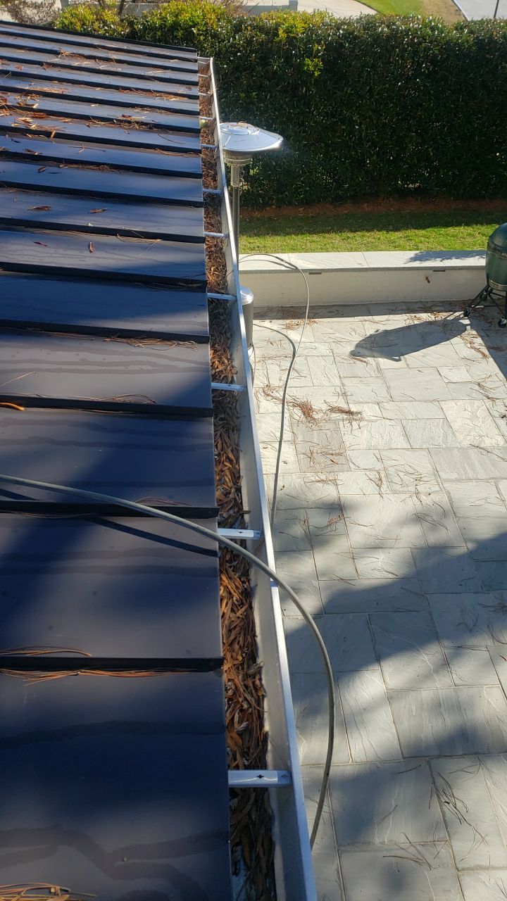 Sara Gutter cleanout using water by Power Wash Masters LLC
