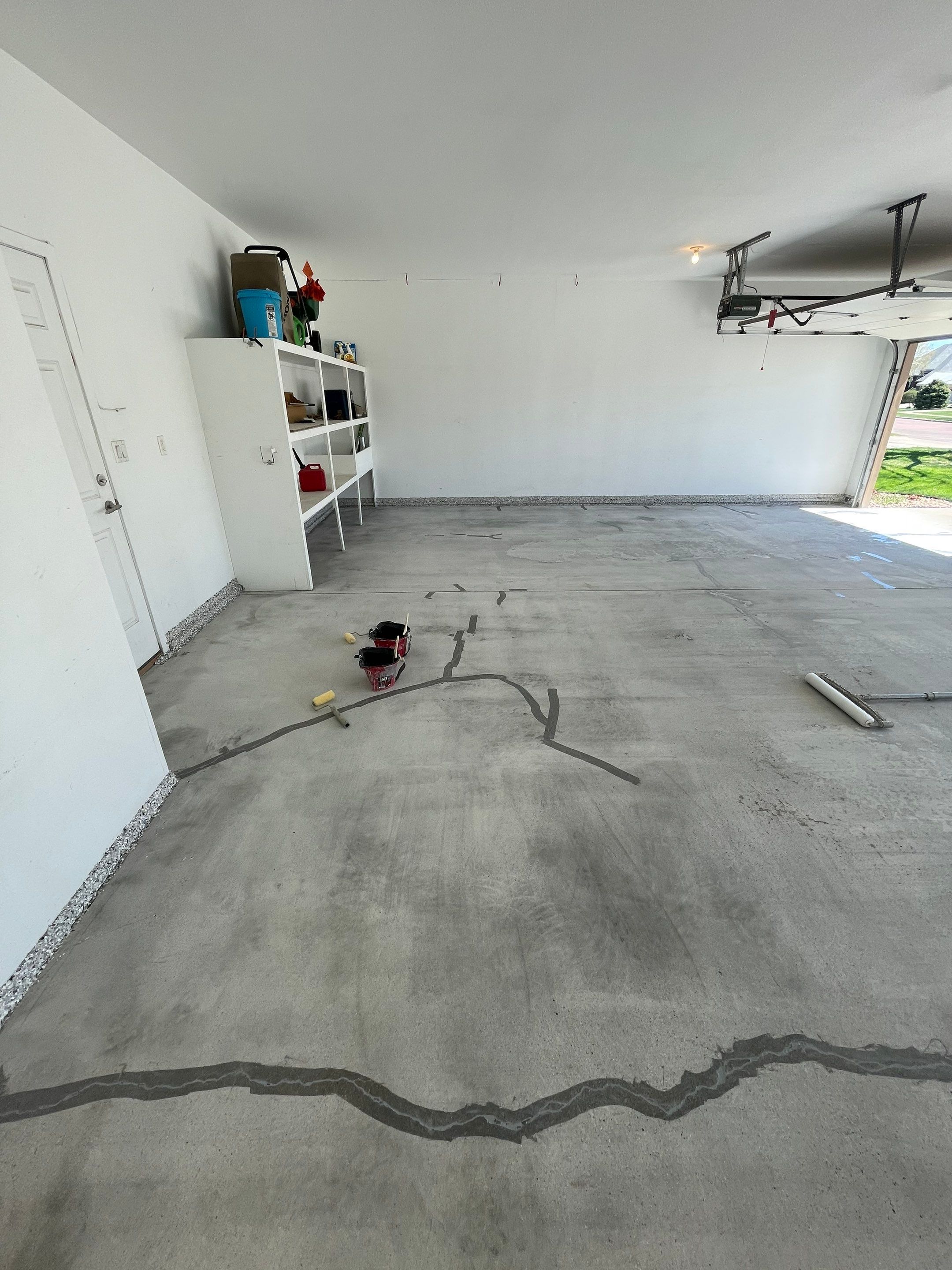 Yankton Garage Floor Restoration with Gray Speckled Epoxy Coating by Select Painting, Coatings & Garage Cabinets