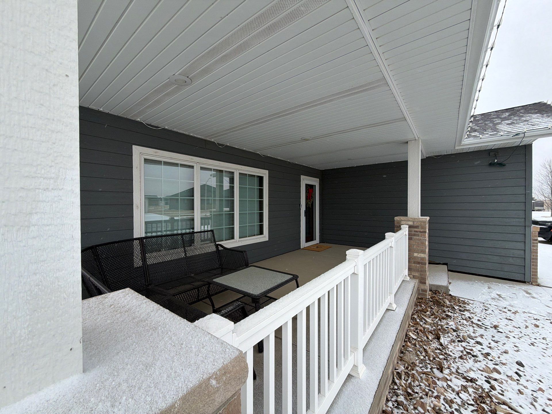 Madison Exterior Remodel with Dark Gray Siding and Stone Accents by Select Painting, Coatings & Garage Cabinets
