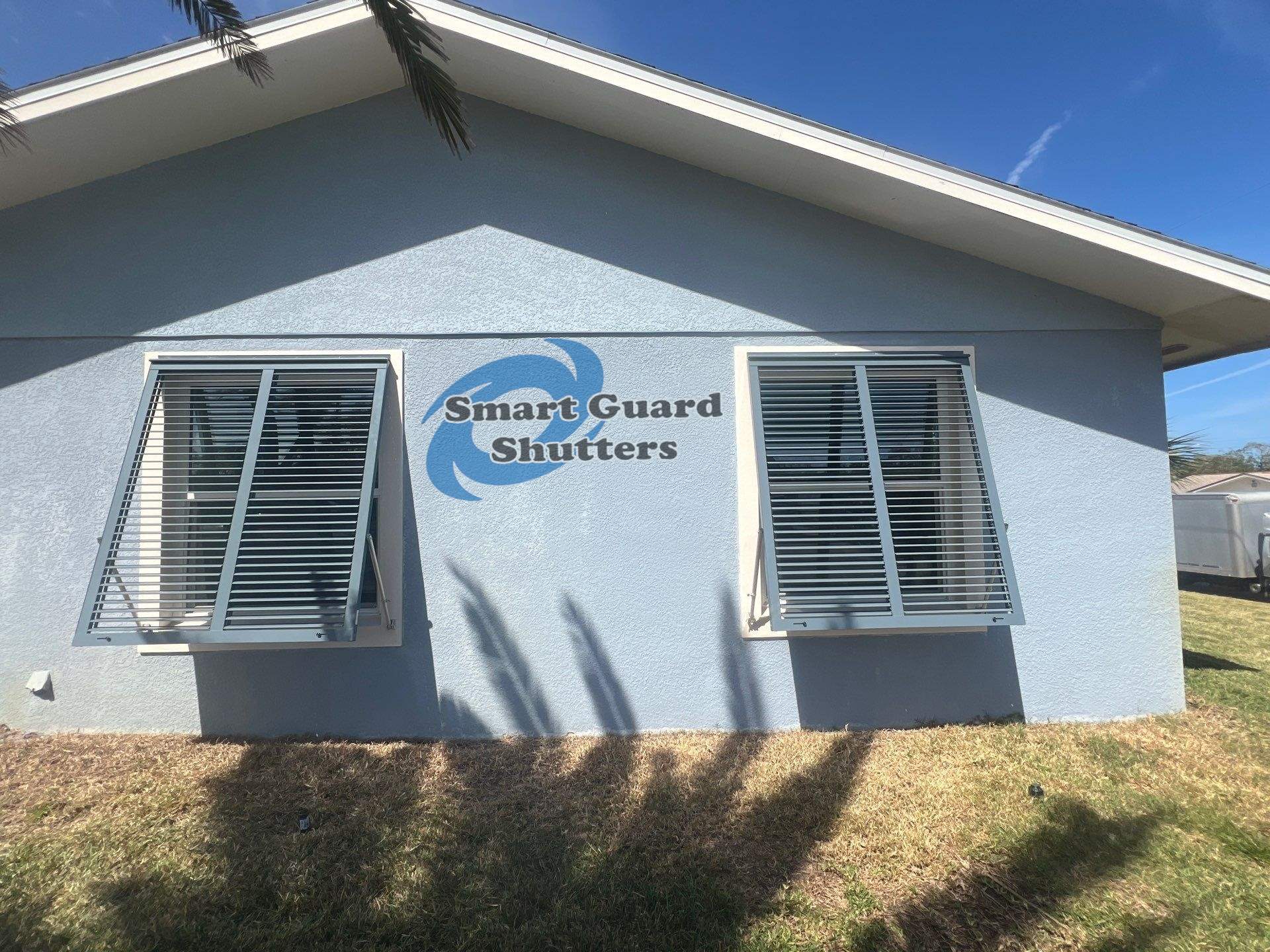 Impact Bahama Shutters in Grey Blue by Smart Guard Shutters