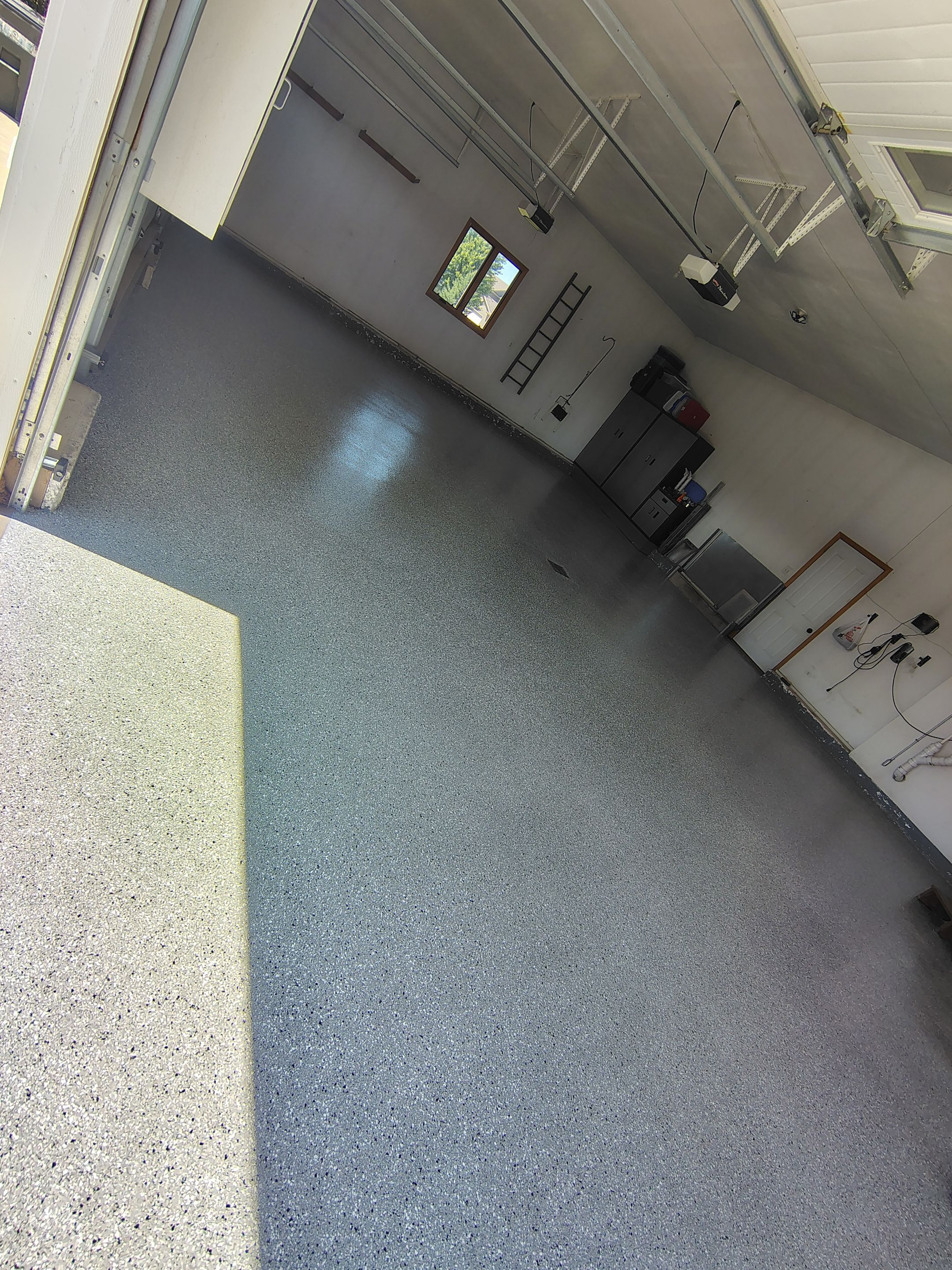 Feather Grey Garage Floor Coating Installation in Valley Springs by Select Painting, Coatings & Garage Cabinets