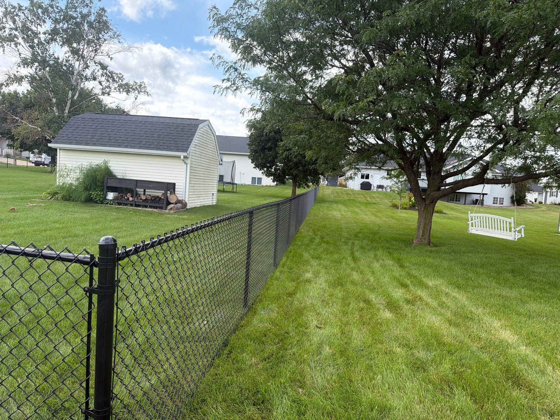 Black Vinyl-Coated Chain Link Fence Installation in Fairbank by Perfect Picket Fence and Stain