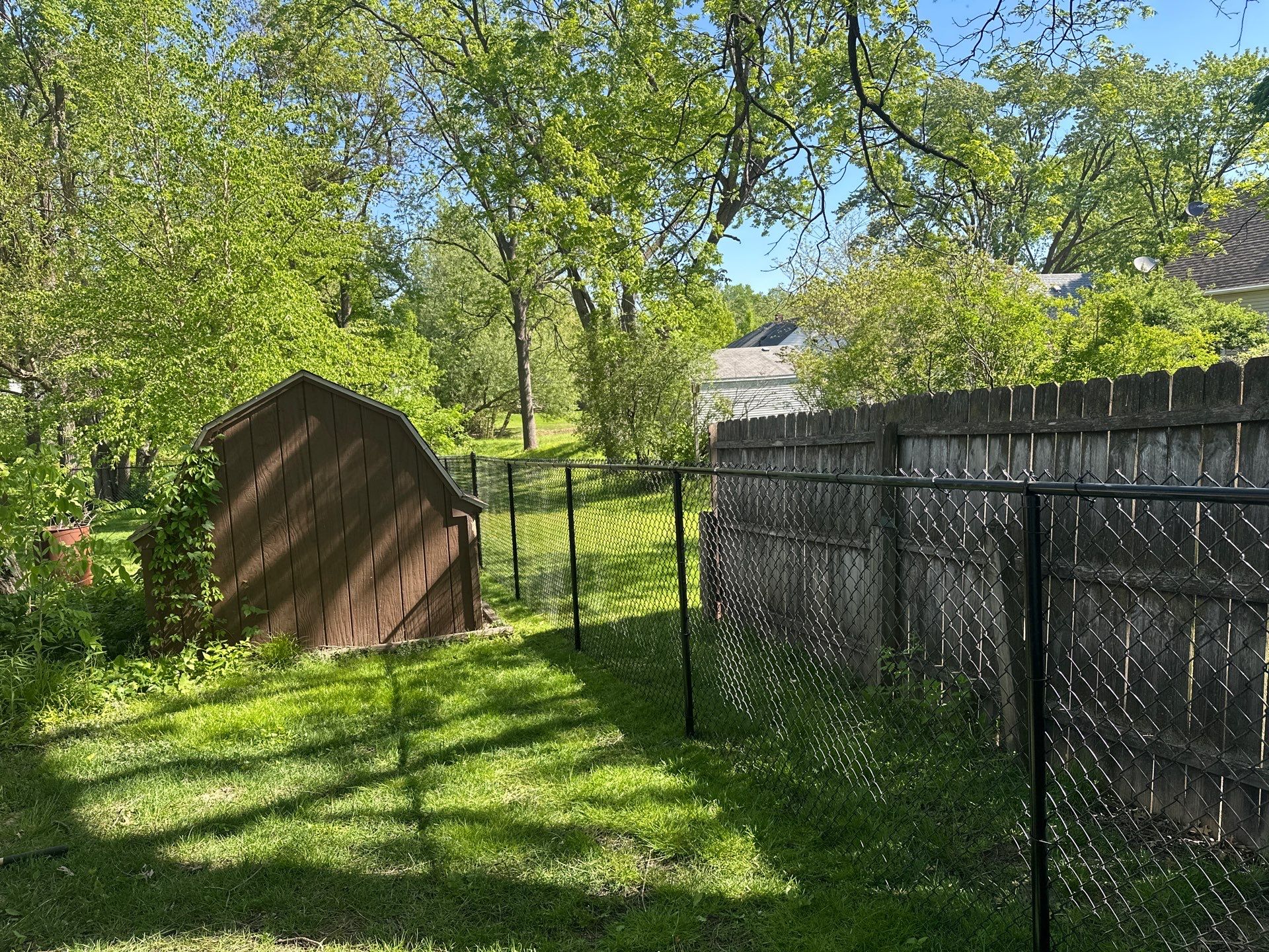 Black Chain Link Fence and Driveway Gate Installation in Waterloo by Perfect Picket Fence and Stain