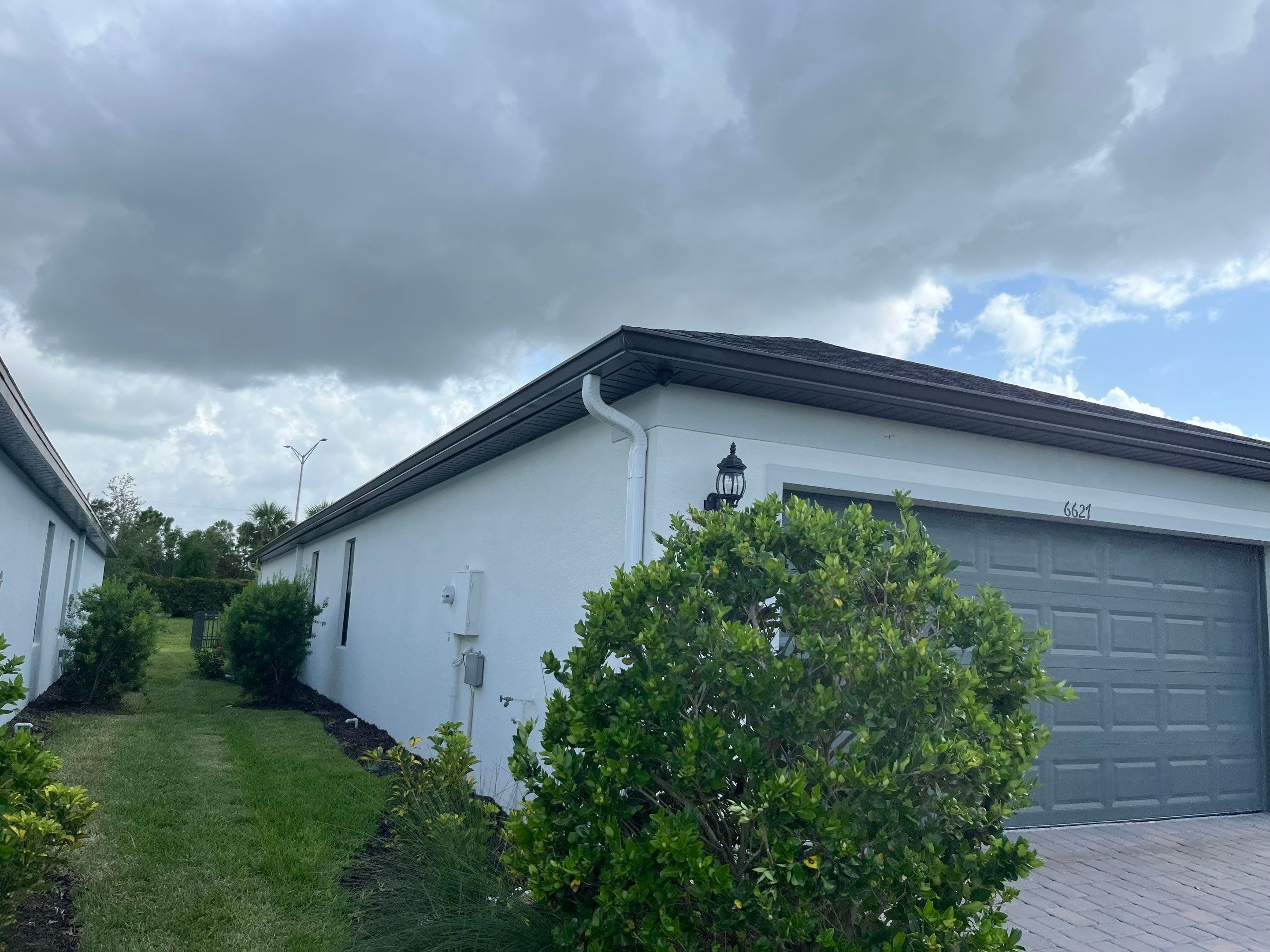 Dark Bronze Gutters and White Downspouts in Sarasota FL by Gutter Professors