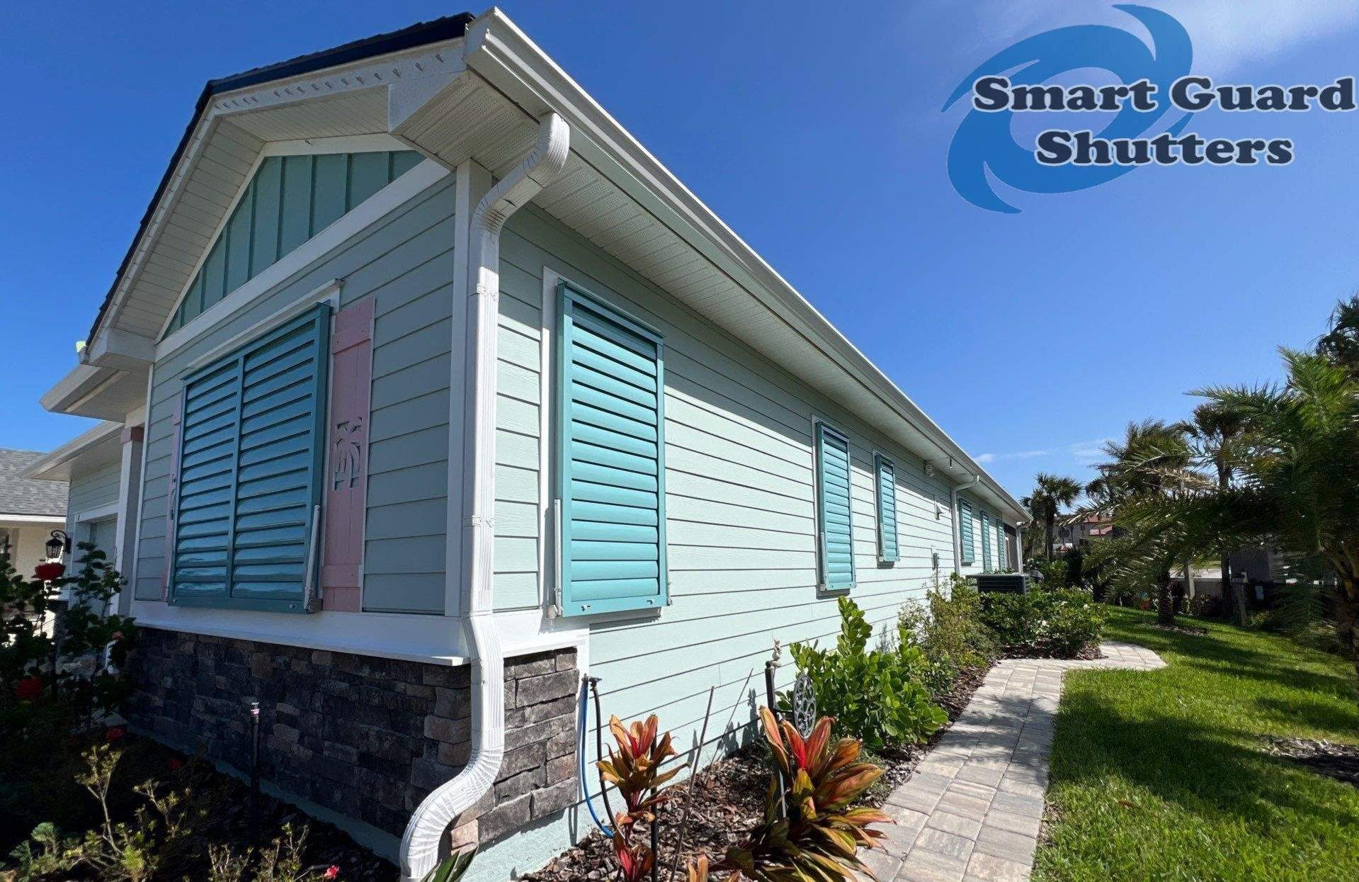 Impact Bahama Shutters in Pastel Turquoise by Smart Guard Shutters