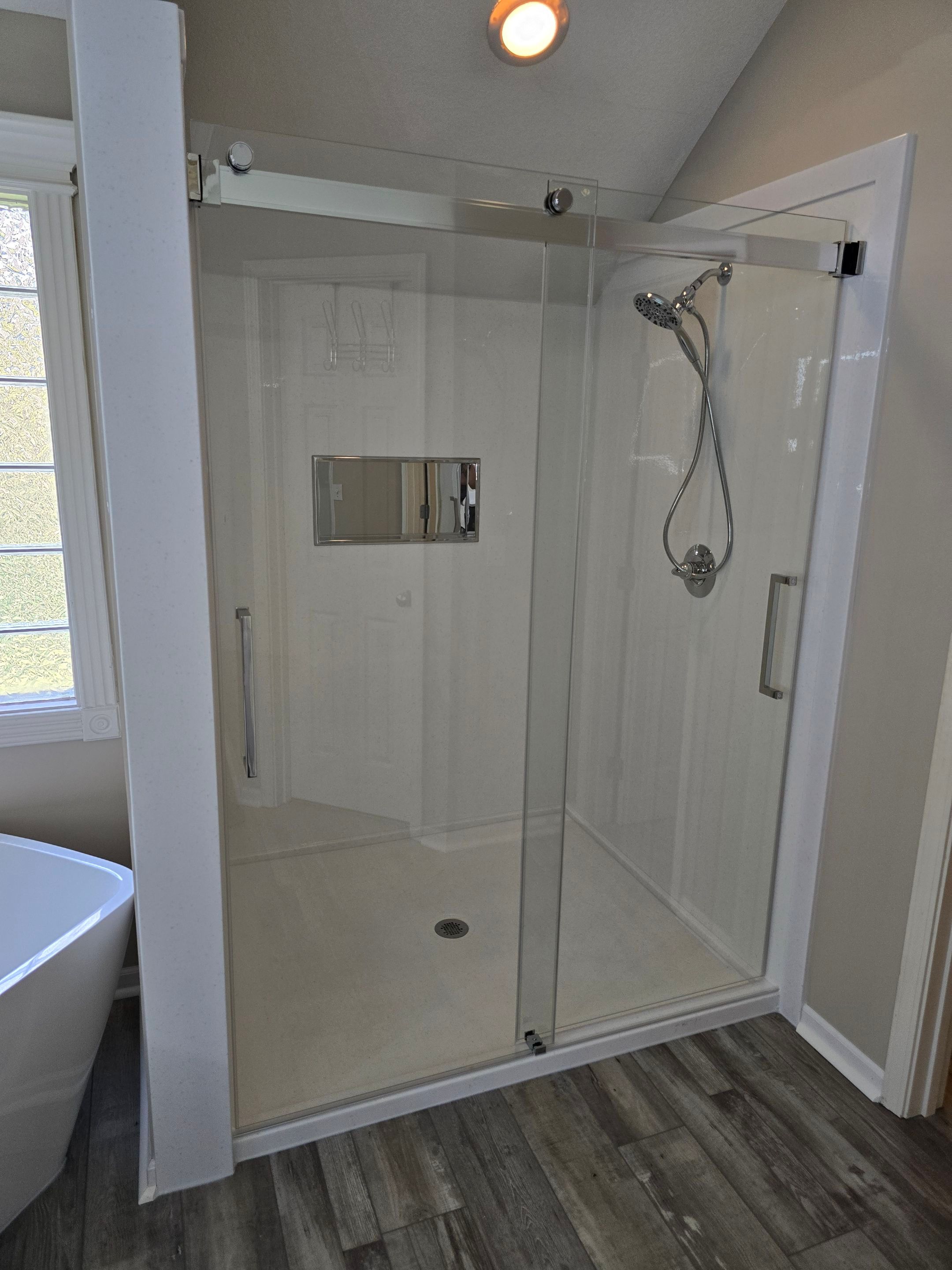 Full bathroom remodel with Artus lighted mirrors, Waltz bathtub and Mercury doors by The Shower Company