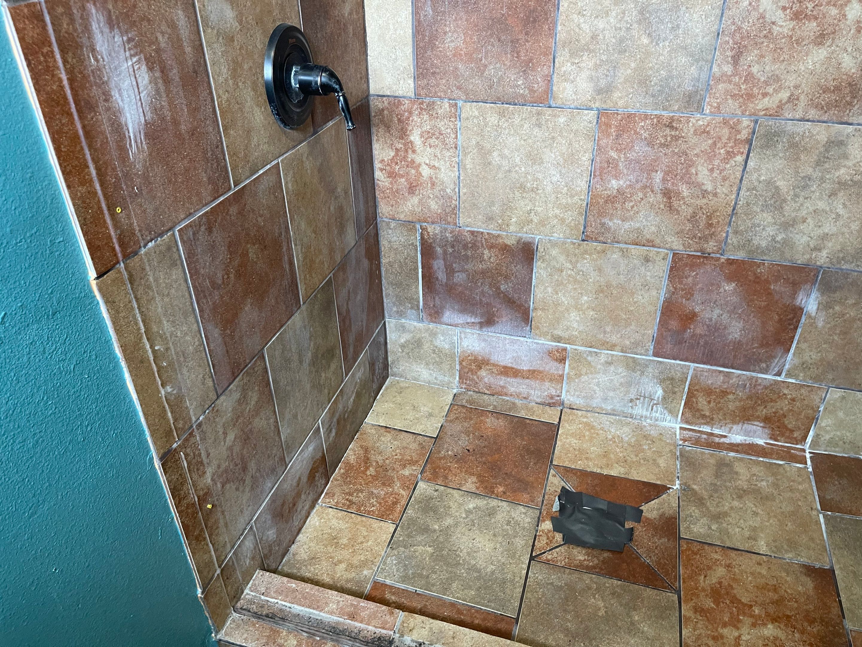 Complete Bathroom Remodel Featuring Marble Tile and Teal Herringbone Niche by Mena stone surfaces