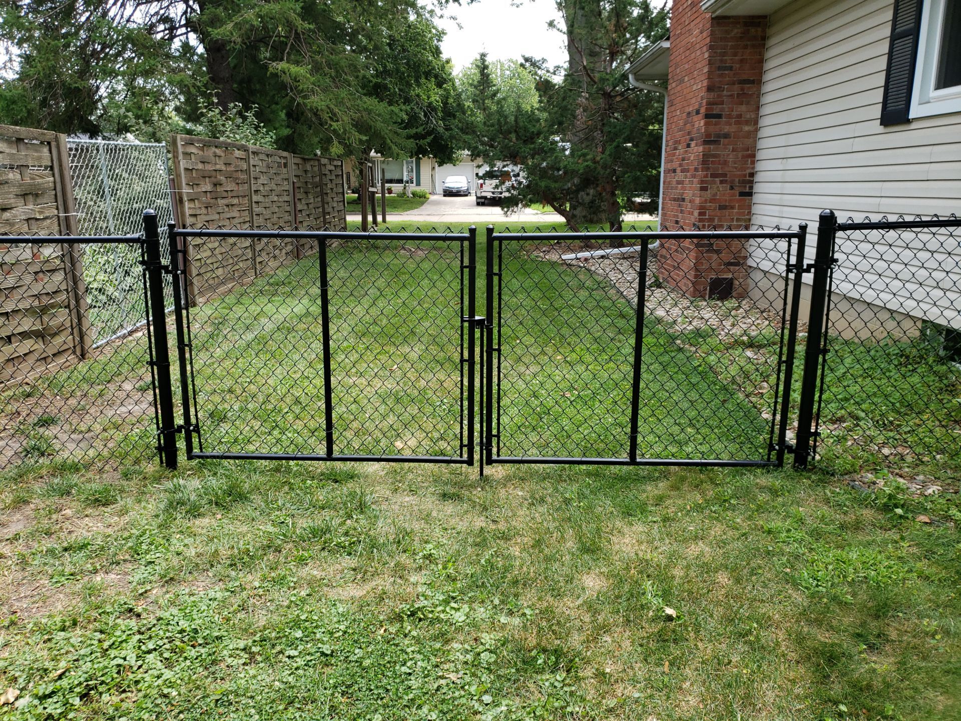 Black Chain Link Fence Installation in Cedar Falls by Perfect Picket Fence and Stain