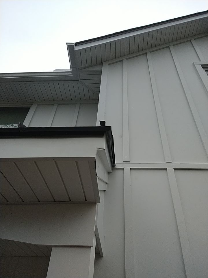 James Hardie Siding  using James Hardie Board and Batten, White by Absolute Roofing and Construction