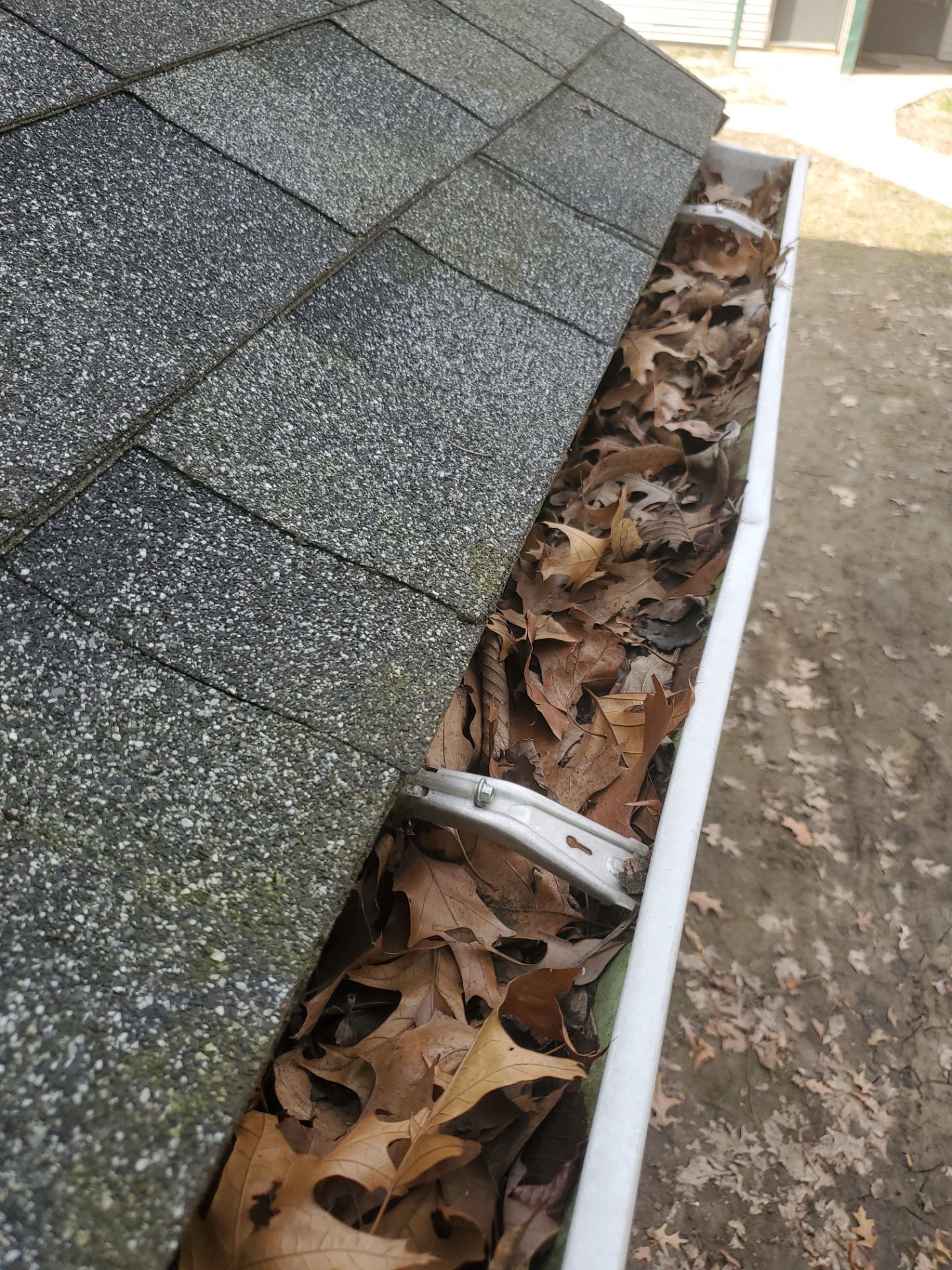 Commercial gutter cleaning Peoria, IL before photo with filled gutters
