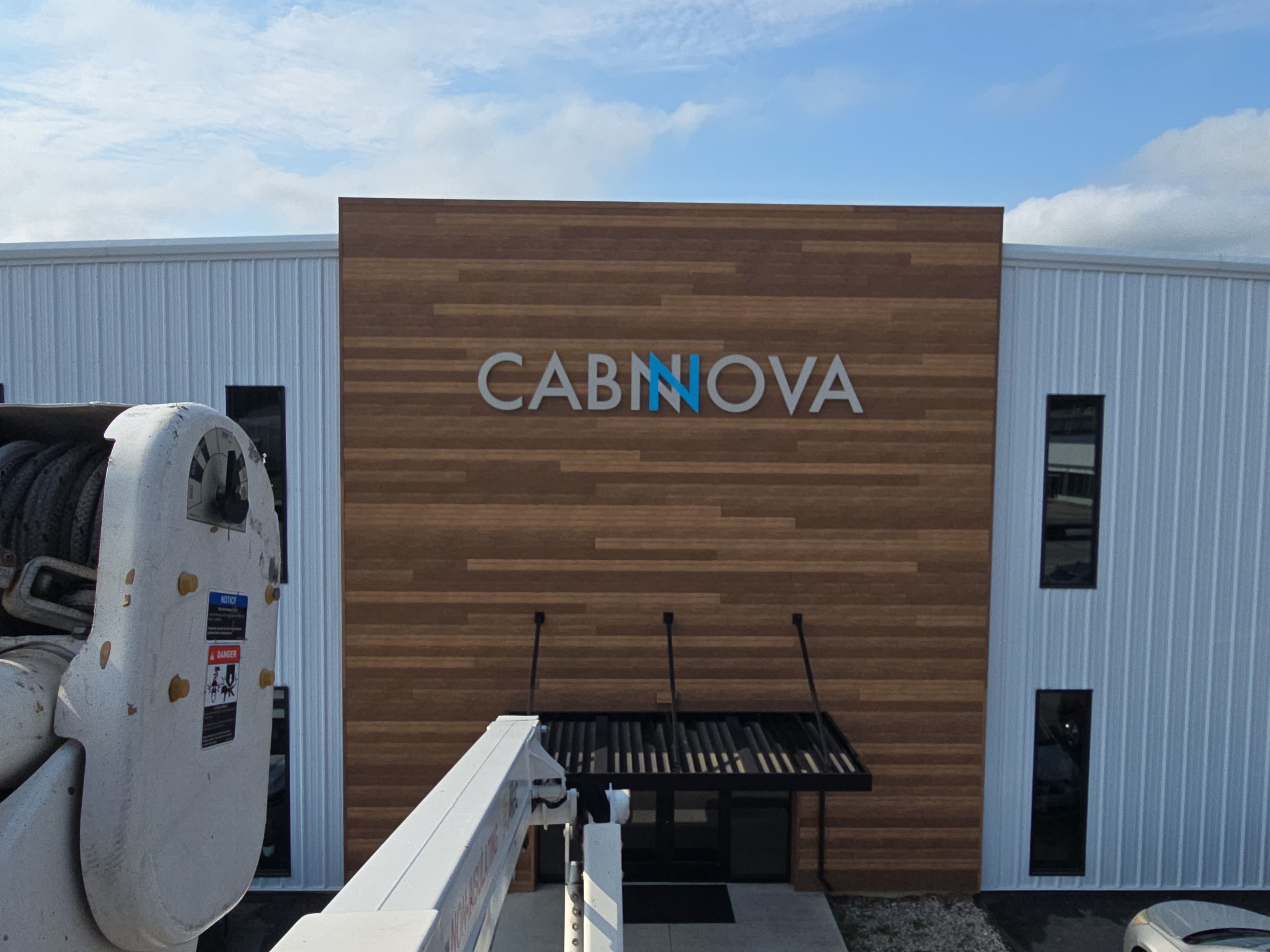 Custom Cabnova Metal Lettering and Wood-Look Panel Installation in Bremen by Hayes Design co