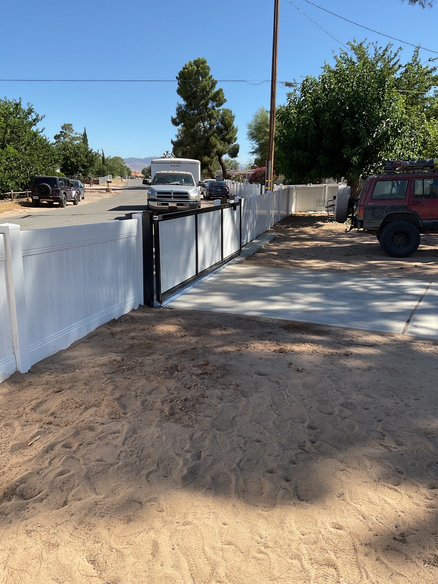 4ft White Vinyl Fence with Solar Power Motorized Gate by Fence Guys Inc.